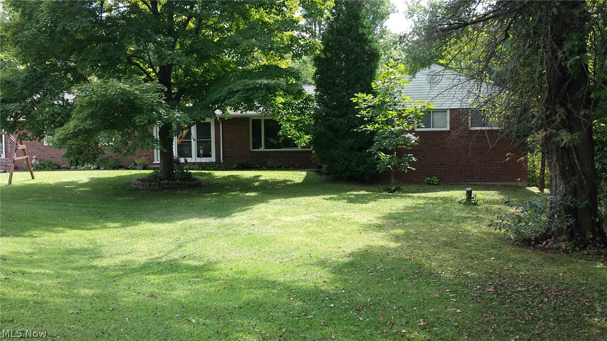 Come home to nature! This well maintained and updated brick ranch has charm and location. The spacious rooms, updated kitchen, baths,  boiler, and electrical, make this home move in ready. The enclosed porch with fireplace adds an additional 312 square feet of living area for large gatherings. The walkout basement has two additional finished rooms. The recreation room with fireplace and a craft room, office or bedroom, adds another 544 Square feet of living area! The acreage is partially wooded, but also has a lovely manicured lawn with a pond, and outdoor picnic area. The two level deck is just a step away from the enclosed porch.