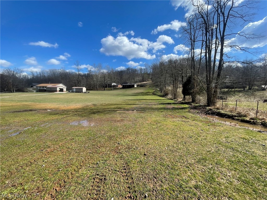 Country Building Lot located on Speed Road consisting of 1.680 acres. This land is part of an existing homestead and is surveyed. There is city water and electric at the road frontage. This parcel is cleared rolling meadow that is kept mowed and has a beautiful building site. The seller is letting a 24 x 12 building stay with the property. The building has a wood floor, has skids and a garage door in front and side man door. This property has a small stream at back of property.  This site is only about 10  minutes from Spencer where many shopping stores are, including Walmart, grocery and hardware . There are many restaurants and other stores along with movie theater, parks and near by lake ,golf course and riding club. If you are looking for a building lot, come see this!
