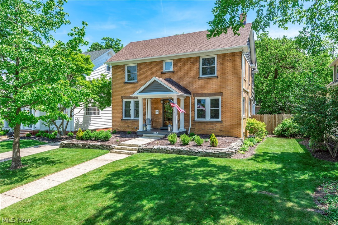 Distinctive slate landscape walls hint at the attention to detail you will find in this brick Colonial. Step through the original beveled-glass French entry door into the welcoming foyer where the open staircase accented by wrought iron railing & brass finials makes a memorable impression. Hardwood flooring throughout the home, including the kitchen, enhances a circular floor plan ideal for entertaining. Living room has an Italian marble fireplace flanked by leaded-glass bookcases. 1/2 bath complements the layout. Designer kitchen offers quartz countertops, glazed ceramic tile backsplash & oversized island w/seating. Two exposed brick chimneys provide a striking contrast to the kitchen's refined finishes, one designed to display a wine collection. Double sink, coffee bar, pot filler & stainless appliances create a cohesive look. Originally a seasonal sun porch, the sunroom has been transformed into year-round living space. Painted brick walls, white wood ceiling & expansive windows create a light-filled room. 2nd floor has 4 bedrooms & generous closet space uncommon for homes of this era. Updated bath includes a soaking tub, shiplap accent wall & tile flooring. Finished 3rd floor features white beadboard walls, ceiling & floors accented by an exposed brick chimney. Well suited as a studio, craft room or meditation space. Improvements: roof, energy-efficient windows, siding, gutters, reverse-osmosis system & whole-house water softener. Mini-split cooling system provides A/C for the house. Backyard showcases brick-edged perennial beds, weeping Japanese maple, flowering dogwood, slate patio & Trex porch. Wood privacy fencing encircles the yard, decorative wrought-iron-style fencing provides an attractive border along the driveway. Oversized 2.5-car garage w/cabinetry, workbench & storage shed completes the property. Beautifully maintained & thoughtfully improved, this exceptional home offers a blend of classic design, modern convenience & inviting outdoor living.