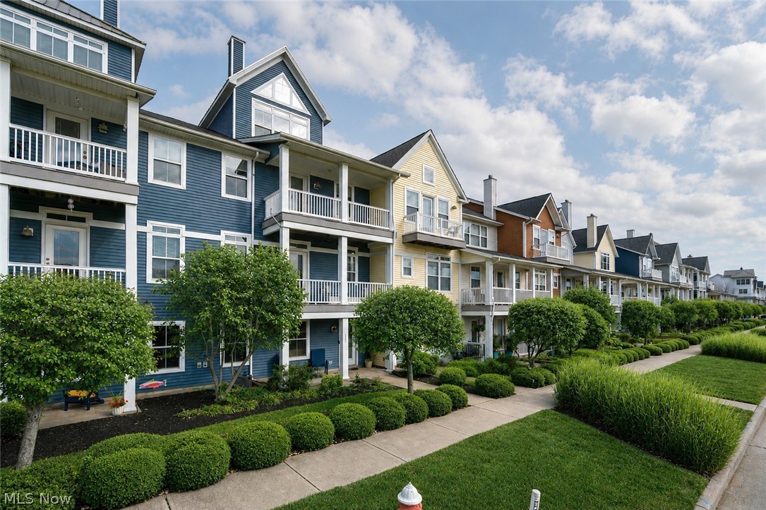 A home like this recently renovated townhome doesn’t come along often. It’s the kind of place where morning coffee comes with river breeze, and evenings carry the soundtrack of live music and waterfront life. This three-bedroom residence stands over the Black River, with boat docks (rented separately) at your feet and Lake Erie in view. From the balconies, you can watch Rockin’ on the River, enjoy fireworks without fighting traffic, or hop the water taxi to join the fun across the river. It’s a lifestyle rooted in community, water, and walkable convenience; there’s nothing else nearby quite like this setting. Inside, the layout is purposeful. Three full stories plus a fourth-level loft, reached by a spiral staircase, create room to live, work, and unwind. That loft makes a natural reading nook, hobby space, or retreat. The ground-floor office is smartly separated from the main living areas, ideal if you work from home or simply want privacy for focused tasks. An attached garage adds daily practicality. The second level is the heart of the home. A true great room, balanced by balconies on both sides, hardwood floors underfoot, and light from every angle. It’s ready for everyday living, easy entertaining, and flexible furniture arrangements so you can tailor the feel to your lifestyle. The bedroom level continues the hardwoods, adding durability and timeless character. Beyond your front door, the amenities seal the value. Residents have access to a fitness center and pool, and a restaurant and event center are just steps away. Walkability here is excellent, whether you’re headed to dining, entertainment, trails, or simply taking in the waterfront. In short, this isn’t just a townhouse; it’s a vantage point on riverfront life, offering space, comfort, and a connection to one of the area’s most distinctive neighborhoods. If you’re ready for a move in ready home that feels like a front-row seat to the best of waterfront living, This one delivers.