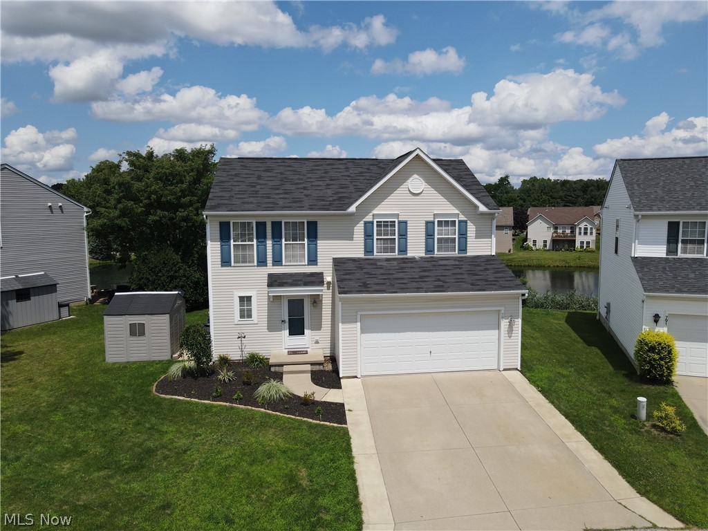Don’t miss this beautifully maintained colonial, with a gorgeous water view, located in the desirable Pleasant Lakes Development! Upon walking through the front door, you are greeted by an open floor plan with a spacious entryway that flows seamlessly toward the large living room. The fully applianced eat-in kitchen is beautiful and bright with fantastic views of the lake from the kitchen sink and the kitchen table! The main floor features a sizable walk-in pantry, convenient mud room, built-in coffee bar, half bath, and closet space. Wonder upstairs to find a huge Master Suite with more amazing views, attached full bath and fantastic walk-in closet. Two good sized bedrooms, additional full bath, and roomy laundry room (including washer/dryer 2021) complete the second floor. The partially finished basement provides extra living space, plenty of storage, and rough-ins for an optional future bathroom. The large rear yard composite deck AND hot tub offer a breathtaking view of the tranquil pond and awesome wildlife – the perfect way to unwind after a long day!  Updates include: Insulated 2 car garage with heater, 12x14 pad on side of house with 8x10 resin shed, water softener system, dishwasher (2023), stove (2023), composite decking (2023), Hot Tub (2022), 50 gal Hot Water Tank (2023), FURANCE AND A/C (2023).  Close to Kent State University, downtown Kent, I-76, and more!