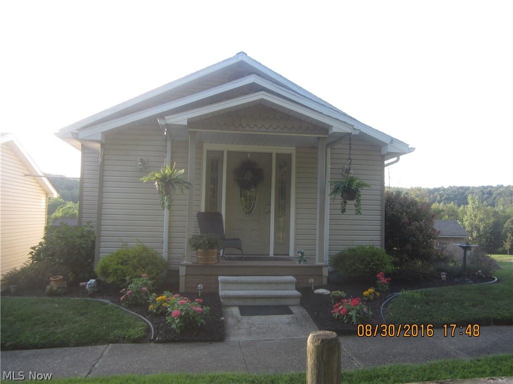New septic installed. Charm and sophistication describe this home.  Warmth and coziness greets you as soon as you walk in the front door.  The decor of the living and dining room has been completely redone with paint, new floor, trim and window coverings.  Two bedrooms and 1 bath off of the living room, with fresh paint and floors.  The kitchen includes gas stove and stainless steel refrigerator.  Walk thru the kitchen to the addition built in 2009 which includes the master bedroom.  First floor laundry.  Down the steps to the basement and then to the family room which walks out to the cement patio.  Outdoor shed is included.  Above ground pool with deck.  New electric 200 amp service, new roof, furnace and windows all in 2009.  The detached garage is currently used for a bike repair shop, has electric and is 24 x 32. Gas average $60/Electric average $75-$150 (higher is the summer with A/C and pool pump running.