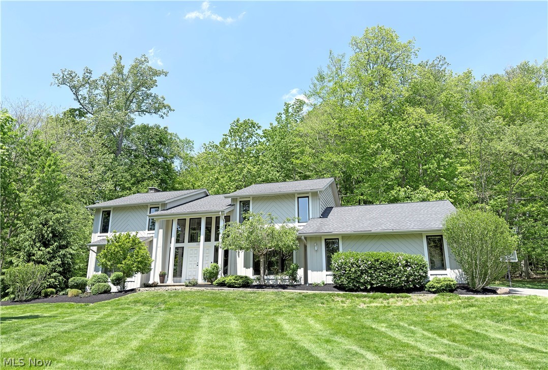 Magnificent contemporary home set on nearly 3/4 acre with a private, tree-lined backyard! A grand staircase welcomes you into the spacious ceramic-tiled foyer, while the formal living & dining rooms are filled with natural light from large front windows. The custom kitchen features cherry wood cabinetry with under-cabinet lighting, granite countertops, KitchenAid appliances, a large island, two sinks, & bamboo flooring. Just off the kitchen, the 4-season room offers cherry wood flooring, walls of windows, & access to 2 outdoor connecting decks overlooking the serene backyard. The family room features a beautiful wood-burning fireplace with built-in shelving. The main level also includes an office, laundry room, & 2 half baths. Upstairs, the vaulted owner’s suite offers a wood-burning fireplace, a Juliet balcony, & a huge en-suite bath with a dual-sink vanity, walk-in shower, jetted tub, a full wall of built-in cherry wood storage, & a walk-in closet. 3 additional generously sized bedrooms and a full bath complete the 2nd floor. The finished lower level includes an expansive recreation room, sitting room, & separate utility/workshop. Additional highlights include a 2-car garage with extra storage, a newer hot water heater (2020), & full exterior paint completed in 2025. This meticulously maintained home combines space, comfort, privacy, & pride of ownership in an exceptional location - contact us for your own personal showing today!
