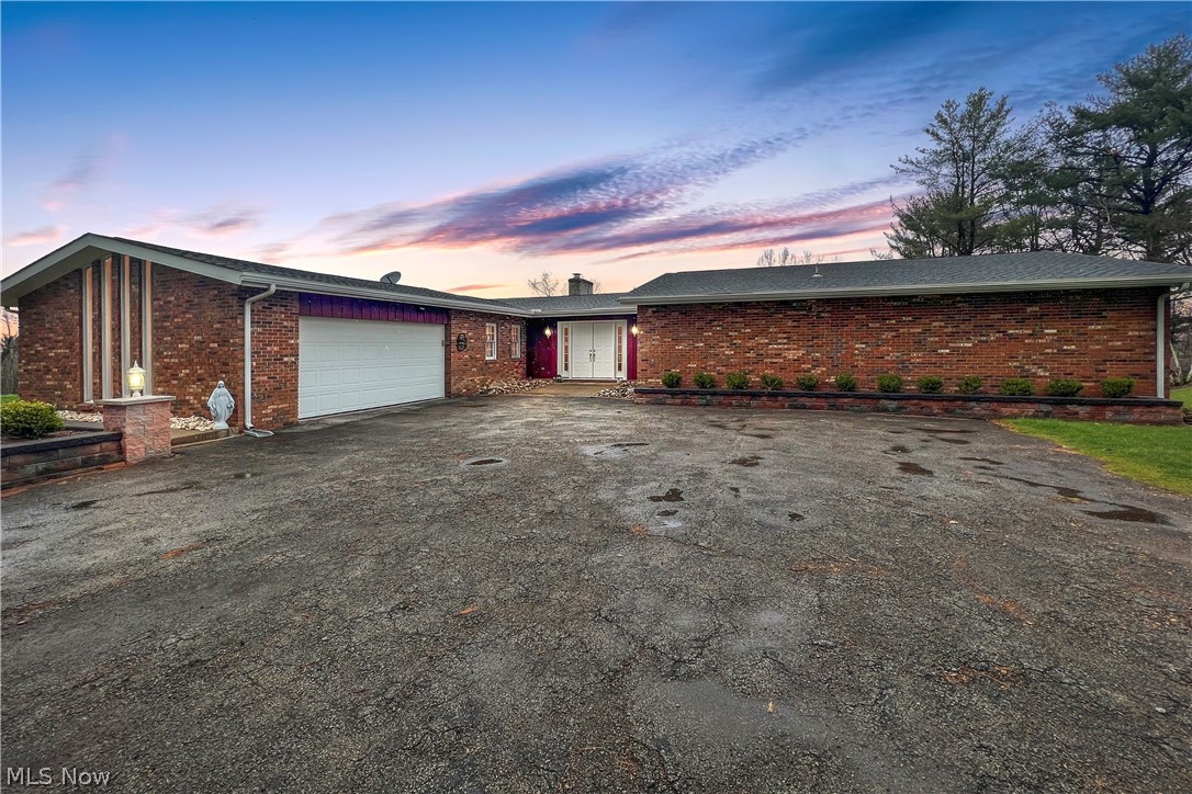 Come check out this beautiful Brick Ranch down a secluded driveway!!  Over 5.97 acres surrounding the property with 2 private porches where you can sit and drink coffee in the morning overlooking the beautiful land. A total of 4 GARAGES, 2 detached and 2 attached accompanied with a big work shop featuring many possibilities. 1st floor laundry right of the kitchen and very convenient by the bedrooms. 3 large bedrooms, 3 full bathrooms, and a huge finished basement that features a full kitchen, full bathroom, a walk out patio,  and a Wine cellar!  Call to set up a private tour of this beautiful property!!