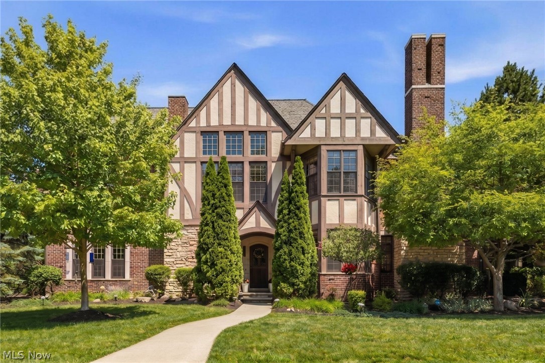 Across from Kirtland Country Club, this custom-curated residence brings estate level detail to the ease of ranch style living. From the arched openings and transom windows, the meticulous millwork and custom built-ins to the hardwood and travertine floors throughout, every room feels layered and intentional. The kitchen is where mornings begin and gatherings naturally linger, with granite counters, a center island, breakfast bar, and bay-window banquette creating an inviting space to settle in. It opens seamlessly into the great room, where a gas stone fireplace, custom Venetian plaster, and French doors spill out to the courtyard patio creating a natural flow from everyday living to evenings spent entertaining indoors and out. The main-level primary wing feels like a retreat within the home, complete with dual walk-in closets and a spa-like ensuite with dual sinks, a walk-in shower, soaking tub, and striking tilework throughout. A second main-level suite gives guests their own beautifully finished space, while the sun-filled formal dining room, den, or study offers the flexibility to host, work, or simply enjoy a quieter corner of the home with access to both private patio areas. Downstairs, the lower level changes the pace entirely, an additional suite, full bath, wet bar and kitchenette with dual beverage fridges, bar seating, and room for movie nights, game days, or long dinners that turn into late nights. Association care goes well beyond mowing, landscaping includes mulching, weeding, and hedge trimming, leaving more time for courtyard dinners, or simply enjoying the setting without a weekend to-do list. With over 3,200 finished square feet, two private outdoor spaces, attached garage parking with plenty of additional guest parking, and another thoughtful detail at every turn, this is not condo living as usual. It is a home that gives you the freedom to host more, stay longer, and enjoy every layer of the lifestyle Kirtland Tudor Estates is known for.