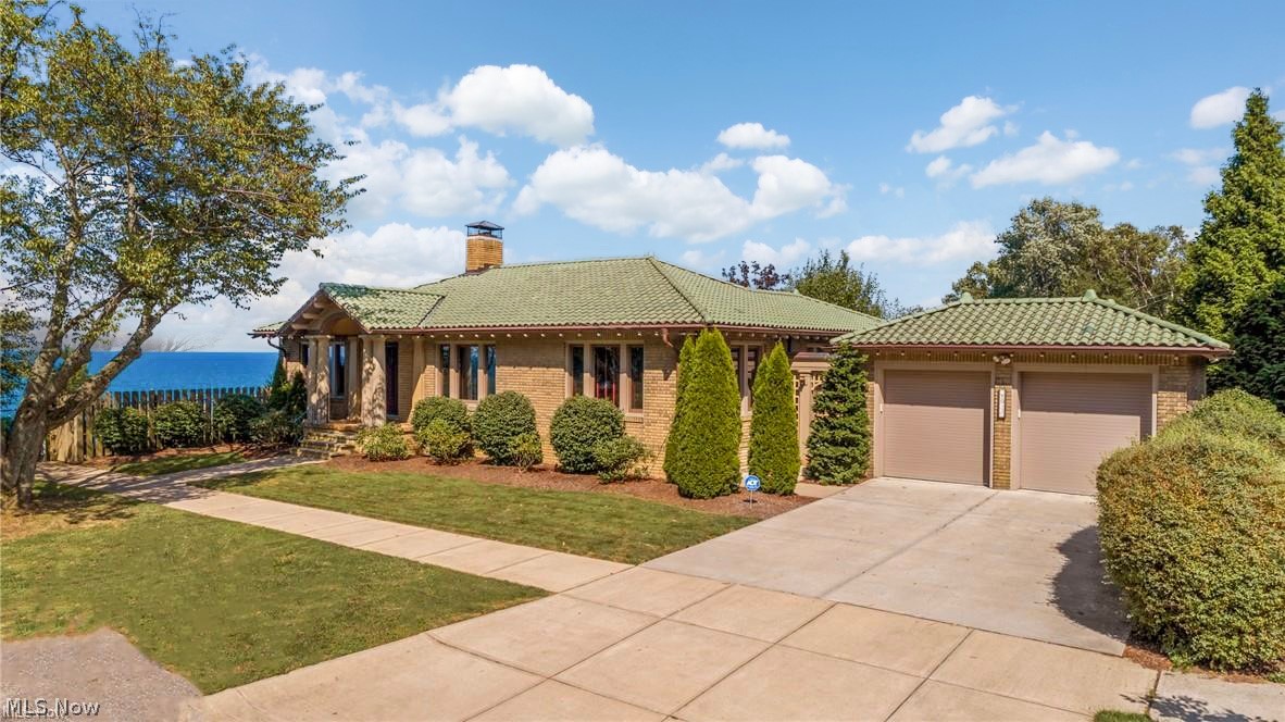 Enjoy one floor effortless lakefront living on a private street in the heart of Lakewood. This stunning craftsman blends timeless architectural character with breathtaking Lake Erie views--offering spectacular sunsets and skyline views!! Enjoy an unmatched sense of serenity. The expansive living room frames the lake as living art, creating a dramatic yet calming backdrop for everyday living and entertaining. V The chef's kitchen features period-style cabinetry, a bold designer backsplash, and professional-grade stainless steel appliances. A formal dining room with custom wainscoting adds refined elegance perfect for hosting family dinners or larger gatherings. Vintage design still works well with versatile living spaces. The main level offers a lakeview primary bedroom with spacious closets, a secondary bedroom, and a beautifully updated full bath. The finished walk-out lower level expands the homes' livability with a third bedroom, full bath, and an exceptional media and entertaining space--Complete with movie projector and oversized screen. A LOCATION THAT ELEVATES YOUR LIFESTYLE. Just six minutes to Downtown Cleveland, with easy access to acclaimed dining, art's districts, and cultural attractions. A rare opportunity to enjoy private Lake Erie front living in one of Northeast Ohio's most vibrant communities! 4th of July Fireworks included