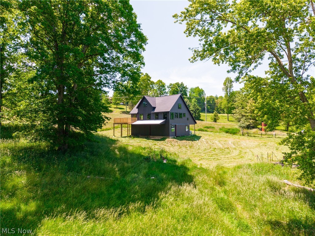 Discover a rare opportunity near Magnolia, OH with this unfinished barn-dominium built in 2022, offering endless potential to create your dream home. Situated on 7.73 picturesque acres, the exterior is mostly complete while the interior awaits your personal touch. The lower level provides ample garage or storage space, the main level features a spacious cathedral-ceiling living area filled with natural light and access to a large wraparound deck, and the upper loft is ideal for additional bedrooms, a game room, or a man cave. The property includes a run-in shed and fencing for livestock, making it perfect for a country homestead, while its proximity to Lake Mohawk, Atwood Lake, and just 35 minutes from Akron-Canton Airport also makes it attractive for short-term rental potential.