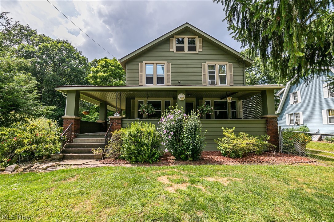 A wonderful, early century charmer in Stow.  With over 1900 sq ft, this home features 4 bedrooms, and 2 full baths.  The wrap around front porch extends almost 70 feet, and covers the front and side.  The oversized living room has a beautiful fireplace, and opens to the large living room.  A large lot is completely fenced, with a patio and additional covered rear porch.  There is a basement, shed, vinyl windows, a second floor laundry, and so much more.