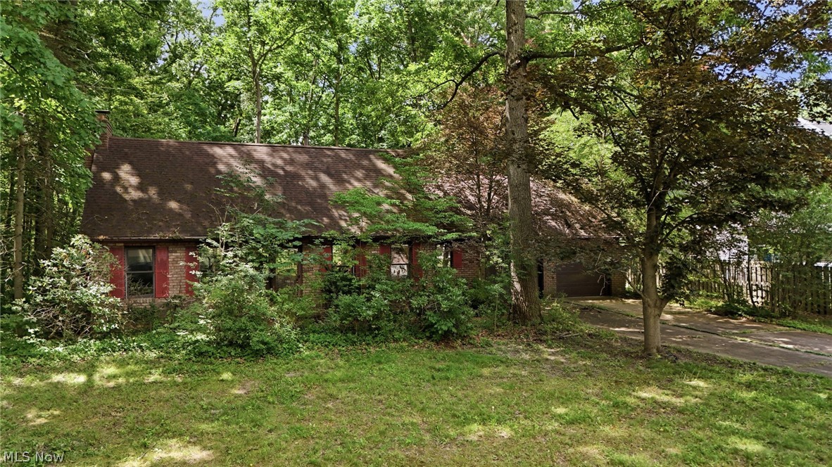 Endless possibilities await in this charming 3-bedroom Colonial tucked away on a quiet dead-end street in Ravenna, Ohio! Step inside and be welcomed by a spacious foyer highlighted by stunning custom wood stairs leading to the second level. The oversized family room offers the perfect gathering space, featuring a beautiful brick fireplace as its centerpiece. A sliding glass door leads to a private three-season room, creating the ideal spot to enjoy your morning coffee or unwind while overlooking the backyard. The formal dining room is filled with natural light from its abundance of windows and provides picturesque views of the private backyard. Flowing seamlessly from the dining room is a spacious kitchen offering ample cabinet and countertop space, making meal preparation and entertaining a breeze. The functional layout is perfect for both growing families and those who love to host guests. Conveniently located just off the kitchen, you’ll find a first-floor laundry room with additional storage space, direct access to the backyard, and entry to the oversized attached garage. A generously sized bedroom and full bathroom complete the main level. The lower level features a full unfinished basement, providing endless opportunities for storage, a workshop, or future finished living space. Upstairs, you’ll find two additional spacious bedrooms and a second full bathroom. With solid bones, a great location, and plenty of room to make it your own, this home is ready for its next owner to add their personal touches and restore it to its full potential. Don’t miss this incredible opportunity—schedule your private showing today before it’s gone!
