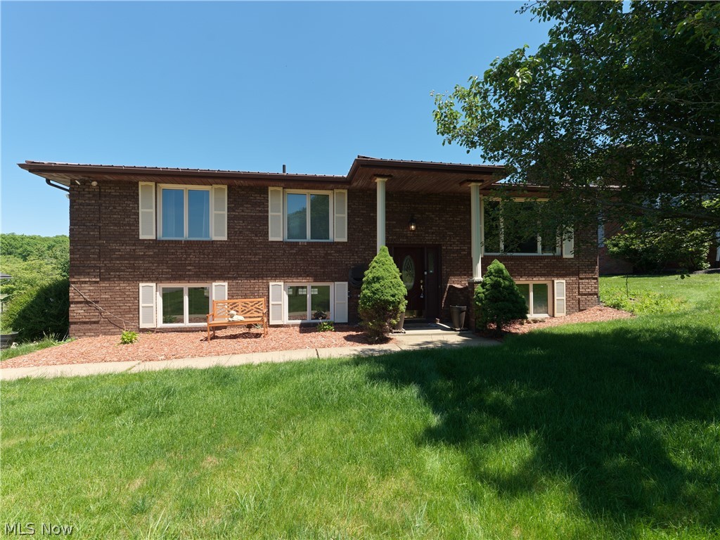 Welcome home to this meticulously maintained all-brick bi-level, where classic durability meets modern sophistication on a beautifully landscaped 0.308 acre lot. Immediate possession is available, meaning you can close and move right in without delay! The bright interior transitions seamlessly from the spacious living room into a fully updated kitchen featuring crisp white cabinetry, modern lighting, and included appliances. Throughout the main level, newer flooring and updated Anderson windows flood the space with natural light, leading to three comfortable bedrooms, including a primary suite with a private ensuite bath. The living space extends into the versatile walkout lower level anchored by a magnificent floor-to-ceiling brick fireplace, custom built-in shelving, and a convenient half-bath—the perfect footprint for a family media room, a quiet home office, or a private guest retreat.Head outside into your private backyard retreat featuring a large deck perfect for summer entertaining, plus a dedicated storage shed for your outdoor essentials. You will enjoy ultimate peace of mind thanks to major mechanical updates including a brand-new roof, a brand-new hot water tank, a 2018 furnace, and an A/C unit replaced within the last decade. Complete with an attached two-car garage, every single detail has been handled so you can simply unpack and start living, so schedule your private showing today before it's gone!
