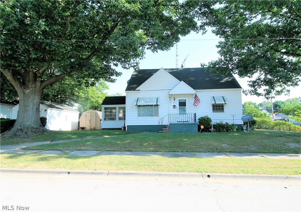 Welcome to this three bedroom, one and half bath cape cod featuring original wood flooring through out the home. From the front porch you enter into the living room that offers a large window to let the natural light to shine through. The bright, eat in kitchen offers a ceiling fan, plenty of cabinets, dishwasher, stove and refrigerator. There is a bright, full bathroom and two bedrooms to finish the main level.  Upstairs you will find another large bedroom and an area great for a desk, etc. The lower level is very clean, offers plenty of room to make a work out area, office, plenty of storage space. Outside you will find a patio in the backyard, great space to entertain or just relax, a shed, and a closed in area with indoor/outdoor carpet to enjoy.  There is a detached one car garage. So many precious memories begin right here!