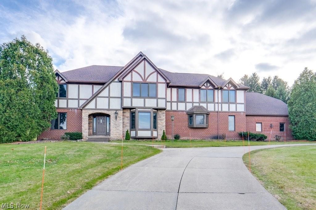 A Great Opportunity to join the desirable Arbour Green Community in a Bath home situated on 1.5 acres on a cul-de-sac nestled on a hillside with a beautiful view is ready to share its architectural excellence to a new owner. With over 5,000 square feet of living space and a fantastic floor plan, high ceilings, and large windows throughout this four bedroom and five bathroom tutor home is just waiting for your finishing touches. Driving up to the grand circular driveway that leads to a spacious three car garage that is positioned on the side of the home. Guests can arrive at the front stone entry arch that opens a two story Foyer, a sweeping staircase, a Home Office, and hardwood flooring that continues into the Dining Room, and Eat-in-Kitchen. The formal Dining Room is lovely with its ornate tray ceiling. Next you will find a large eat-in-Kitchen with a generous dinette area, center island, panty, bay window sink, and access to the backyard and patio. Just down the hall you find a large Laundry Room, huge closet, and access to the garage. In the back of the house you will find a Great Room with an extraordinary two-story opening to the second floor with a wood paneled surround that has intricate mill work with a fireplace and mantle, wet bar, and plenty of windows with views of the private backyard. The Living Room is also on this floor along with two half bathrooms and plenty of room to make this space a 5th Bedroom. Upstairs the Primary Bedroom Suite has a spacious walk-in closet, a glamour bath with jacuzzi tub, separate shower, and two sinks. Two of the bedrooms upstairs share a Jack and Jill bathroom. The fourth bedroom has a full private bathroom and a walk in closet. All four bedrooms have a wonderful view of the Great Room and windows that look out to the private neighborhood. The 1700 sq ft Family Room is in the lower level and is carpeted and freshly painted and has a 12 course ceiling height.