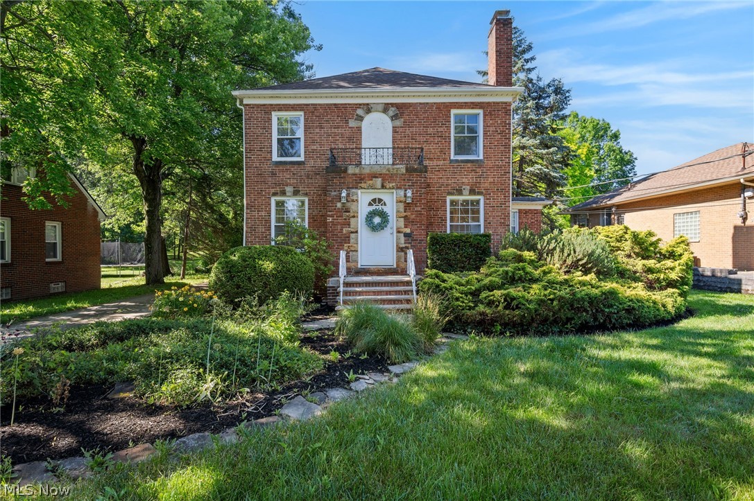 Set on a deep, wooded acre, this colonial offers space in every direction. A two-car garage connects via enclosed breezeway, with a second drive-through garage or workshop beyond; ideal for the hobbyist, collector, or anyone who simply wants room to spread out. Inside, the living room centers on a gas fireplace, with room to spare for both a full seating arrangement and an additional sitting area. The formal dining room, finished with wainscoting, leads to an eat-in kitchen where an island overlooks an oversized bay window framing the yard. A small office with built-in storage and a convenient half bath are tucked just off the kitchen. Upstairs, three well-proportioned bedrooms share an updated full hall bath, while the primary suite offers an attached bath with double vanity and step-in shower. The full basement extends the living space further, with finished space at the base of the stairs with potential for more in the large central room, plus a rear storage room and laundry/utility space. Outside, a paver patio with a small garden and room for planters sits beyond the attached garages, with views reaching across the property to the woods. Furnace (2024), AC (2024) and AprilAire ventilation system (2024). Centrally located with easy highway access to both Cleveland and Akron.