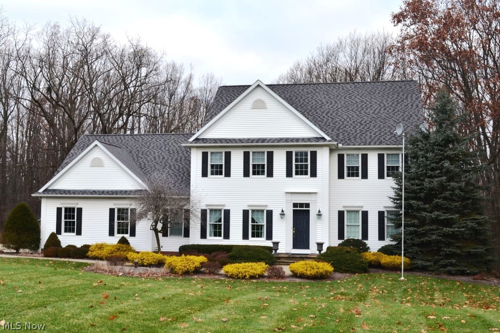 Beautifully appointed and stately colonial on a picturesque 2+ acre wooded lot.  Attention to every detail and meticulously maintained throughout. This home feels much newer than its' age with bright, airy living spaces and open floor plan.   Grand foyer offers gleaming hardwood floors and view of the open staircase.  Handsome first floor library features wall of built-ins and new carpet.  Exquisite formal dining room boasts wainscoting and stacked crown molding. Fabulous sunken great room highlights walls of transom windows, gas fireplace with fluted columns, and built-in entertainment center.  Gourmet cherry kitchen offers island/breakfast bar, bar sink area, and separate eating area with French doors to expansive deck.  Spacious laundry and full bath complete the first floor.  Vaulted master suite presents gas fireplace, h/h walk-in closets, and glamour bath with double vanities and Jacuzzi soaking tub.   Two additional generous sized bedrooms with en-suite baths complete the second