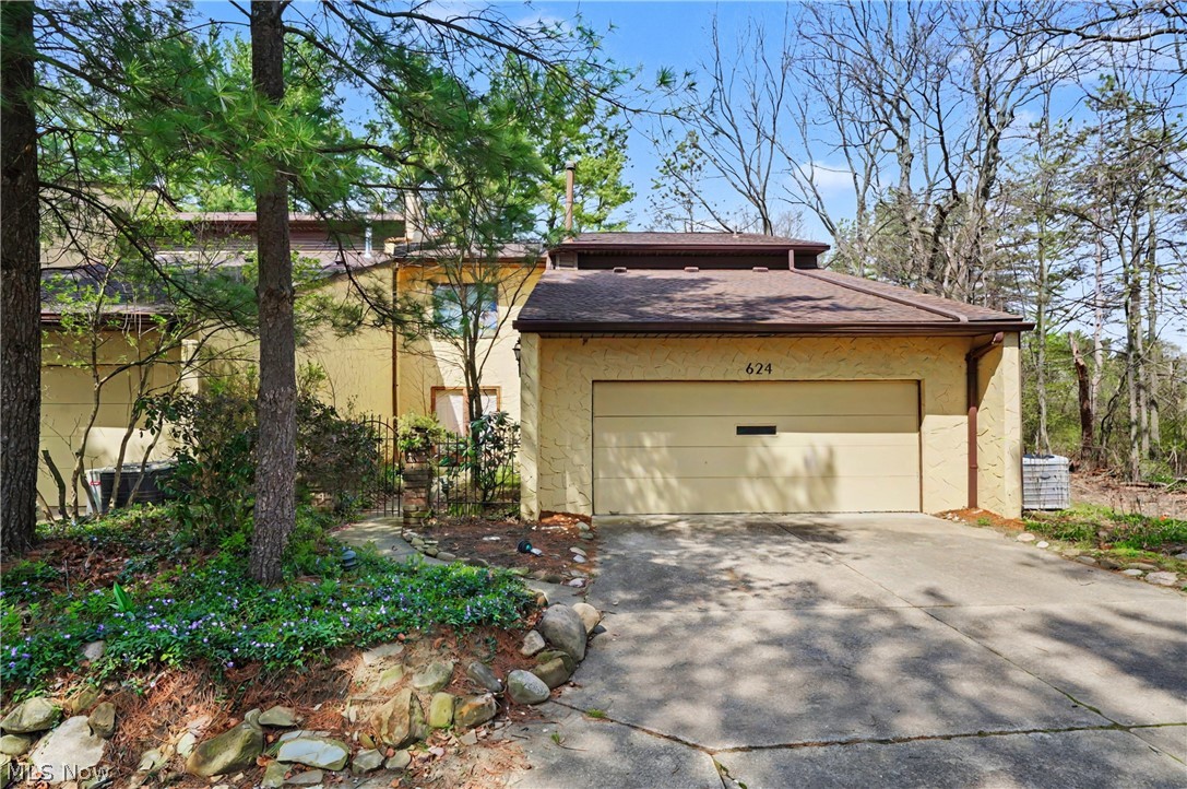 Unbelievable - rare, spacious end unit next to the Seiberling Naturealm, still owned by original family! Enter through private front courtyard through double doors to grand foyer with cathedral ceiling, skylights, chandelier and stained glass window.  Straight ahead is wet bar closet on the left as you enter the huge living room with fireplace and two sets of sliders to brick patio, with dining room area in the back and another chandelier.  Continue on to the eat-in kitchen with all appliances, white cupboards, granite countertops, ceramic tile floor, eating area and half-wall looking into family room with 2nd fireplace and 2 more sets of sliders to the brick patio.  Next is bonus room which could be first floor bedroom or office, with closet and entry to full bathroom with step-in shower, then out to oversized 2-car garage with lots of shelving/cupboards, opener, spigot, drain and pull down stairs to attic storage.  Upstairs is a loft area outside of two spacious bedrooms that both have double closets.  There's also two linen closets, full bathroom with tub and corian counter vanity, and laundry room with utility tub.  Then you enter the large primary bedroom with small balcony, two walk-in closets, two more linen closets and primary bathroom with corian counter with double sinks, garden tub, water closet, and step-in shower.  With some updating and sweat equity, you could have a fantastic home in a fantastic location!  Make an appointment today and bring your decorating ideas.