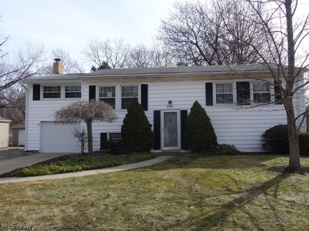 Lots to offer with this cute bi-level in the heart of Stow.  Main living area features 2 bedrooms, kitchen, dining room, living room, and rec room. Basement is partially finished and walks out to back yard and the huge out building/workshop. Attached one car garage, sun room, and nice lot complete this package.  Needs some TLC, but is a great value.