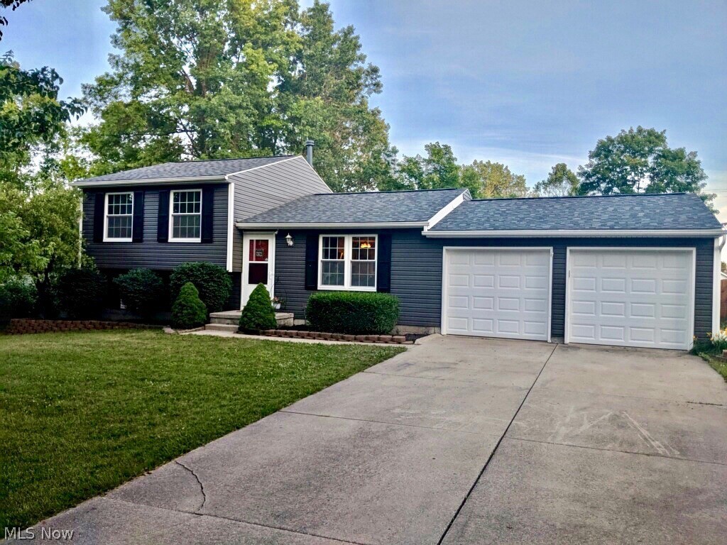 This 3 bedroom, 2 full bath Split Level in Stow is the home you've been waiting for!  You will be welcomed by the newer siding and roof as you pull into the paved driveway and 2 car attached garage.  The completely updated kitchen has refinished cabinets, backsplash, matte finish granite countertops, and new appliances. French doors open from the kitchen to a large screened porch & patio for relaxing and entertaining.  The stair cases are custom pallet wood. Bruce hardwood floors on the main level flow from the living room into the kitchen.  A large Barn door decorates the family room as well as serving as a divider between the two levels.  The custom framed television was made for the Media Room and play room. Enjoy the extra space of the finished basement, with laminate flooring. Shelving has been added in the basement and garage for extra storage.  Schedule your appointment to see this move in condition, freshly painted, neighborhood home today.