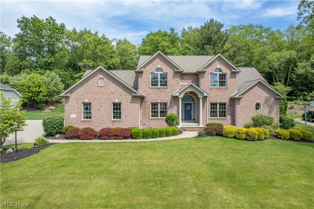 Set on a beautifully landscaped half-acre lot in Aberdeen Ridge, this impressive contemporary home offers over 3,600 finished square feet designed for comfort, function, and entertaining. A vaulted, pillared covered front porch opens to a grand two-story foyer with a wood staircase and inviting sense of space. Just off the foyer, French doors lead to a private office with crown molding, while the formal dining room features a tray ceiling, chair rail, and elegant feel.
The spacious eat-in kitchen is the heart of the home with granite counters, stainless steel appliances, double oven, breakfast bar, walk-in pantry, and bay-window dining area overlooking the backyard. From here, step out to the concrete patio or flow into the soaring two-story great room with high ceilings, large windows, and a fireplace.
The first-floor primary suite offers vaulted ceilings, a large walk-in closet, and an en-suite bath with dual sinks, jetted soaking tub, and separate shower. A wide hallway provides access to the extra-deep three-car garage, half bath, storage, and convenient first-floor laundry.
Upstairs, the open landing overlooks the great room and connects three generous bedrooms, including two with walk-in closets and a Jack-and-Jill bath, plus a junior suite with its own private full bath. The finished lower level adds a large rec room, kitchenette, dining area, bedroom, full bath, built-ins, bonus space, and unfinished storage.
Outside, enjoy mature landscaping, retaining wall, rock accents, front and back irrigation, and a spacious patio. Additional highlights include central vac, abundant storage, concrete driveway, and an extra-deep three-car attached garage in desirable Jackson Township.
