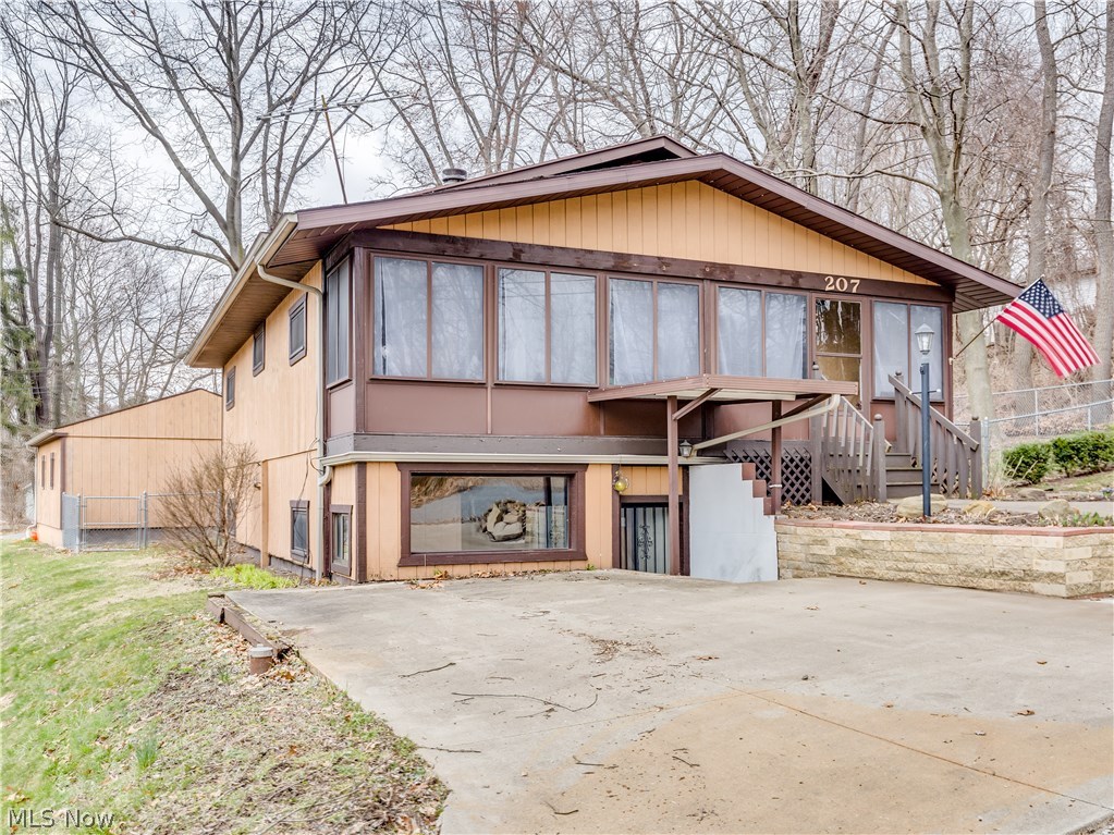 Enjoy ranch style living with a short walk to the water.  This one is an outdoor lovers dream with plenty of nooks and porches to enjoy.    The enclosed front porch provides plenty of sunshine.  Arrive through the front door to a spacious open floor plan with a fireplace, built in shelving and plenty of room to spread out.   The dining area/kitchen has patio doors leading to the fenced in side yard.   The walk out basement hosts the other two bedrooms and a separate entrance.   The lower level second bath is connected to one of the bedrooms and  leads to the laundry and utility area.   Lots of flexibility in this one.   Ideal set up for extended family living or even a rental suite.  Extra parking pad in front, or turn on Falcon and park by the garage and alley.  Windows 2013.  Furnace 2005.  AC 2012.   Well has been chlorinated and checked in 2017.