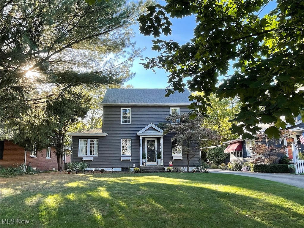 Love, care and good taste are the hallmarks of this gorgeous colonial in West Akron's sought-after Castle Park neighborhood. Brimming with character, and the compliment of carefully-chosen updates, the home will be one you'll want to make yours for a very long time. From the curb you'll see a lovely tree-lined street and the pampered yard. Upon entry, you have terrific sight lines of the 1st floor. You're welcomed by a pretty sitting area with built-ins, that leads perfectly into a light, bright living room with lots of windows and natural light, a gorgeous dining room, comfortable family room and bright 3-season sunroom, both which open to the rear yard and patio. You will have wonderful outdoor parties, here. The kitchen was very important to the owner. She had it remodeled with a mix of modern, versatile cabinetry including large pot and pan drawers, soft-close elements, arabesque tile backsplash and there's even a wall-mounted television! It's large enough for the cook and a couple of helpers, too. With every imaginable convenience you'll wonder how you did without it. On the second floor you'll find a beautiful master suite with three closets and a remodeled owner's bath. Two additional good-sized bedrooms, built-ins for storage and an another remodeled full bath complete this level. Have a teenager who wants his or her own space? The third level can serve as a perfect space for a private bedroom or office. Improvements include a new electrical panel and flooring in 2025, water heater in 2022 and a full roof tear-off on the house and garage, with new gutters, in 2020. Even more than all of this, the owner said she will miss the rare and precious sense of community, including wonderful public and private school options, and truly special neighbors out walking, running and riding bikes, who stop to say hello and who love being part of something special. Make plans to see this one today. You won't want to let it pass you by!