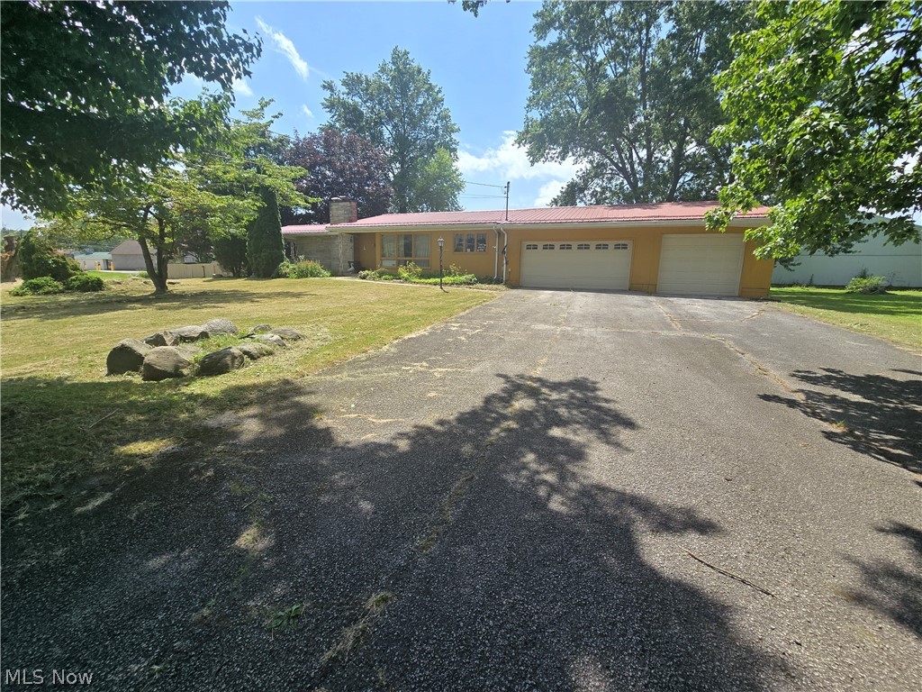 Endless potential in this large ranch home. 3 bedrooms on the main floor with one and a half full baths. Large eat in kitchen with formal dining room overlooking the front yard through large floor to ceiling windows. Livingroom opens up to a covered patio and fenced in back yard. Partially finished basement with large game room with fireplace for entertaining, full bathroom, work room and laundry room. 3 car attached garage and large driveway for parking. Bring your