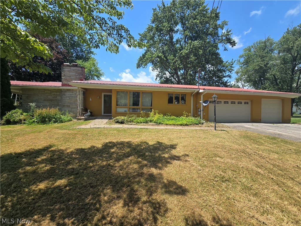 Endless potential in this large ranch home. 3 bedrooms on the main floor with one and a half full baths. Large eat in kitchen with formal dining room overlooking the front yard through large floor to ceiling windows. Livingroom opens up to a covered patio and fenced in back yard. Partially finished basement with large game room with fireplace for entertaining, full bathroom, work room and laundry room. 3 car attached garage and large driveway for parking. Bring your