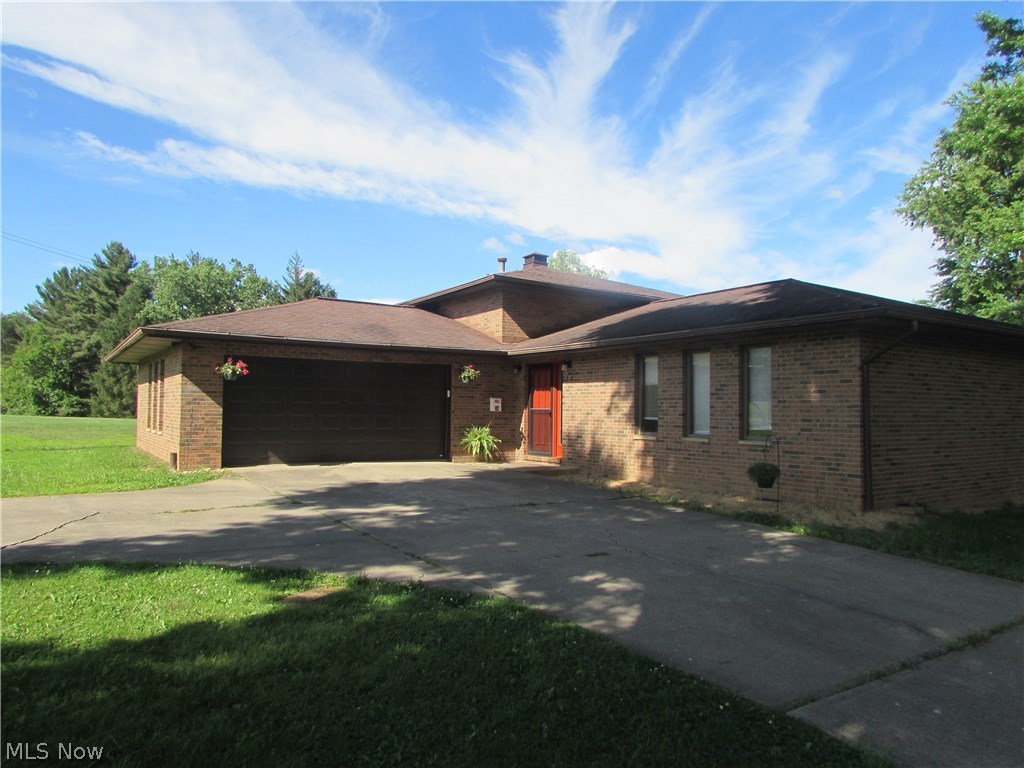 Tri-Level brick home with 3 bedrooms, 2 full and two half baths. Living room, kitchen and separate dining area. Plus large family area in lower portion of the home with fireplace and entrance into the laundry and storage room. There is also entrance from the 24 x 24 attached garage into a mud room access to a 1/2 bath. The covered 12 x 20 back porch offers a shaded area on the hot summer days with trees as well. There is also a smaller 14 x 24 garage plus a 11 x 26 tool building for storing mowers or ATV's. Offering almost .91 acre lot. Close to North Bend Golf Course and North Fork Hughes Rive Lake and dam