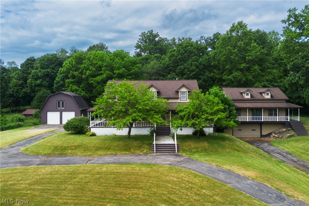Welcome to this impressive custom home situated on approximately 4 beautiful acres in the highly desirable South Range School District, offering space, privacy, and versatility for modern living. Featuring just under 4,000 square feet of living space, this property includes 4 bedrooms, a first-floor master suite, an in-law suite, 4.5 bathrooms, and a finished basement, making it ideal for multi-generational living, entertaining, or those simply seeking room to spread out.

The spacious kitchen is designed to impress with new appliances, granite countertops, ample cabinetry, and generous workspace for cooking and gathering. The home's thoughtfully designed layout provides comfortable living areas, large bedrooms, and abundant natural light throughout. The first-floor master suite offers convenience and privacy, creating a relaxing retreat complete with a spacious layout and well-appointed bath.

The finished basement adds valuable living space and can serve as a recreation room, home theater, fitness area, or additional entertaining space.

Recent upgrades include new carpeting, upgraded HVAC, water softener equipment, and a new heat pump.

A standout feature of this property is the incredible 40' x 60' two-story detached garage/shop, built with 8-inch concrete flooring and equipped with three overhead doors. Whether you're a car enthusiast, contractor, hobbyist, or need extensive storage space, this building offers endless possibilities.

This exceptional property combines the comfort of a spacious home with the functionality of an extraordinary outbuilding, all within the highly regarded South Range School District. With extensive living space, a first-floor master suite, private in-law accommodations, and significant recent upgrades, this one-of-a-kind estate offers the perfect blend of luxury, practicality, and country living. Schedule your private showing today!
