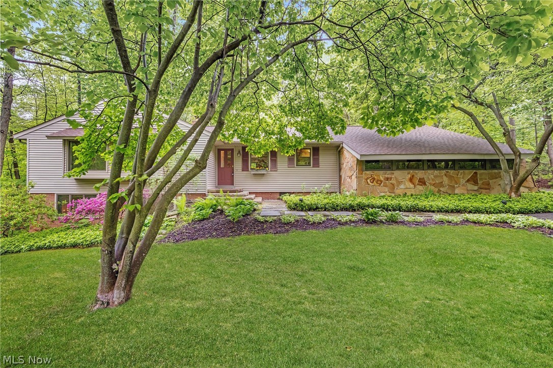 Gorgeous, 3-Bedroom, 3-Full Bath, Mid-Century Modern Ranch nestled in a serene, storybook setting in Bath Township. Pride of ownership shows in the meticulous maintenance and many improvements made over the past 38 years. This beautiful and truly unique home just keeps getting better and better with each additional, thoughtfully completed project. Along the way keeping true to the MCM aesthetics for feeling, flow, and function. A few examples... 1) The Kitchen was taken down to the studs, expanded and remodeled with classic UltraCraft cherry cabinetry, sleek granite countertops, and premium stainless steel appliances. A granite breakfast bar and planning station, and decorative light-up niche were added. Oak hardwood flooring was installed. The oak hardwood flooring throughout the rest of the home was refinished and recoated to match the newly installed oak flooring in the Kitchen. 2) A reconfigured floor plan created space for a 20 x 11 Primary Bedroom with two walk-in closets and Ensuite Bath with tumbled marble flooring and tile and an Infinity Whirlpool and walk-in shower with Kohler Performance Showering Accessories. Recessed lighting was added to the Bedroom’s two original window seats, creating lovely reading nooks or enjoyable displays for thriving indoor plants. 3) Backyard deck with built-in seating and adjoining brick patio was extended so it could reach the full length of Bedroom 2 and wrap around entire back of the home offering expanded backyard living space with distinct zones for dining, lounging, or grilling. Two Bedroom 2 windows were replaced with an Andersen sliding glass door for easy access to deck and Mother Nature. And, there’s so much more! See Supplements for full list of updates, including newer roof (2024). This wonderful home is a must-see! Great location offers peaceful feel of a country retreat with convenient access to big city amenities, all within a 30-minute drive to Cleveland and Akron.  Schedule your private showing today!