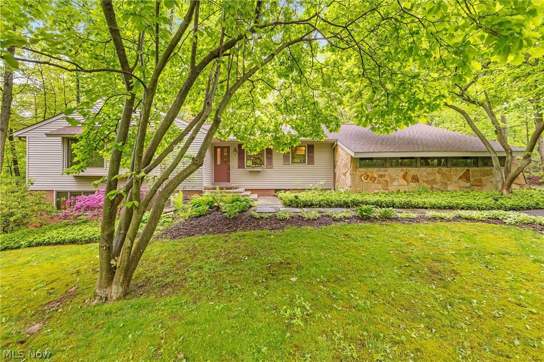 Gorgeous, 3-Bedroom, 3-Full Bath, Mid-Century Modern Ranch nestled in a serene, storybook setting in Bath Township. Pride of ownership shows in the meticulous maintenance and many improvements made over the past 38 years. This beautiful and truly unique home just keeps getting better and better with each additional, thoughtfully completed project. Along the way keeping true to the MCM aesthetics for feeling, flow, and function. A few examples... 1) The Kitchen was taken down to the studs, expanded and remodeled with classic UltraCraft cherry cabinetry, sleek granite countertops, and premium stainless steel appliances. A granite breakfast bar and planning station, and decorative light-up niche were added. Oak hardwood flooring was installed. The oak hardwood flooring throughout the rest of the home was refinished and recoated to match the newly installed oak flooring in the Kitchen. 2) A reconfigured floor plan created space for a 20 x 11 Primary Bedroom with two walk-in closets and Ensuite Bath with tumbled marble flooring and tile and an Infinity Whirlpool and walk-in shower with Kohler Performance Showering Accessories. Recessed lighting was added to the Bedroom’s two original window seats, creating lovely reading nooks or enjoyable displays for thriving indoor plants. 3) Backyard deck with built-in seating and adjoining brick patio was extended so it could reach the full length of Bedroom 2 and wrap around entire back of the home offering expanded backyard living space with distinct zones for dining, lounging, or grilling. Two Bedroom 2 windows were replaced with an Andersen sliding glass door for easy access to deck and Mother Nature. And, there’s so much more! See Supplements for full list of updates, including newer roof (2024). This wonderful home is a must-see! Great location offers peaceful feel of a country retreat with convenient access to big city amenities, all within a 30-minute drive to Cleveland and Akron.  Schedule your private showing today!