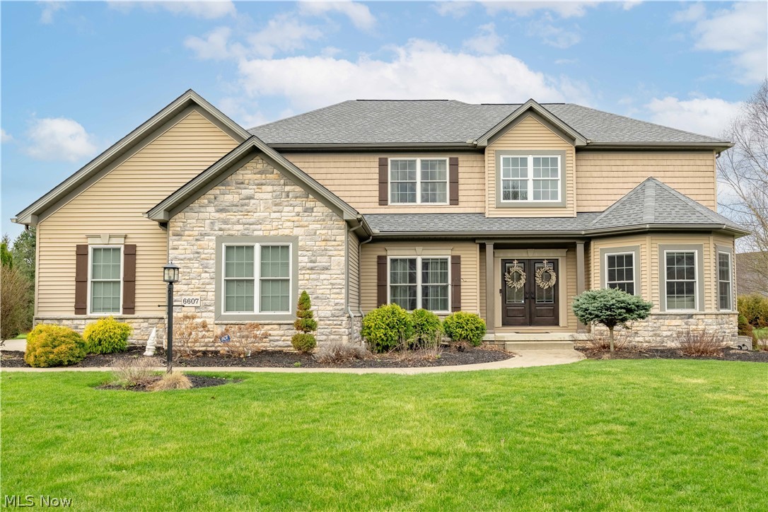 This expansive home built by Skip Rea, located in the desirable Mudbrook Village of Jackson Township, offers an exceptional combination of space, comfort, and convenience. Tucked away on a quiet cul-de-sac yet just minutes from town, the setting and yard provide the perfect balance of privacy and accessibility.

A beautifully landscaped walkway leads to the entrance, where you’re welcomed by an impressive two-story foyer. From here, you’ll find access to a private office, formal living room, and a well-appointed gourmet kitchen. The spacious kitchen features maple cabinetry, stainless steel appliances, and new granite countertops, including a large island with breakfast bar, added workspace, and a cozy dinette area.

Just beyond the dinette, a newly added four seasons room provides a relaxing space to enjoy views of the well-maintained backyard. Back inside, the formal dining room offers ample space for entertaining and flows seamlessly into the main living area. The great room is highlighted by a gas fireplace and abundant natural light.

The main level also includes a convenient half bath, while the second floor features three full bathrooms. An additional full bath is located in the fully finished, expansive basement, which also includes a bedroom with a egress window.

Upstairs, all four bedrooms are generously sized and thoughtfully designed. The owner’s suite features an oversized walk-in closet and a luxurious bath complete with a Jacuzzi tub, double sinks, and a separate shower.

With a total of approximately 4,450 square feet of living space, this home truly has it all. In addition to its many features, it offers abundant closet space and storage throughout, along with the convenience of first-floor laundry. Recent updates include the roof, entry doors, light fixtures, and more.