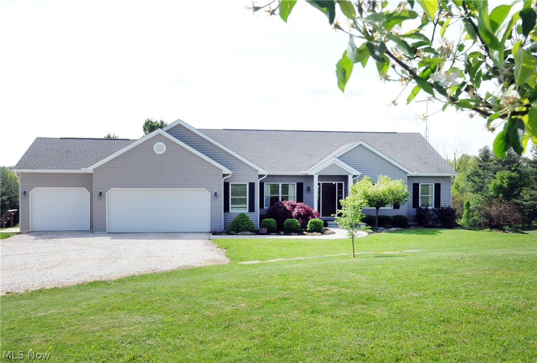 It isn't often that a superb single story home with a 3-car attached garage, on a gorgeous country setting of 6 acres, on a paved road, comes on the market but today is your lucky day! Sitting quietly down the driveway you'll be greeted with lush landscaping framing the entry to this well-cared for residence. Inside you'll love the open floor plan and high ceilings that offer both convenience and style. The spacious kitchen shows off plenty of counter space with gorgeous oak cabinets plus additional space with the island breakfast bar. The laundry room is conveniently located between the garage and kitchen. The Master suite offers more than enough room for your king-size bed and a master bath with garden tub and separate shower. The sliding glass doors from the dining area lead to a pillared back porch and a delightful dining patio that overlooks a lush, park-like yard. You will picnic in the park in your own backyard. Call now to make this amazing home yours. The security system is a