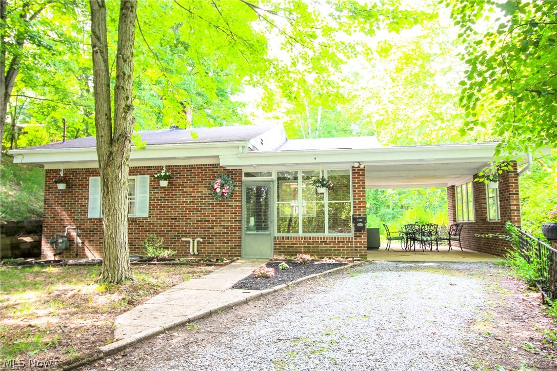 Rehabbed estate on nearly 3 beautiful wooded acres in City of Green! Endless opportunities on this private parcel that includes a darling all brick home set back from the road to create a private setting. Quality all brick exterior with poured basement walls; true hardwood & new laminate flooring in kitchen/bath. Very clean inside! 4 car garage including 2 bays attached to the raised ranch and a great outbuilding for a workshop. New furnace & water heater (2016). New refrigerator and stove (2021). Affordable opportunity for acreage, lot splitting, and/or additional outbuildings.