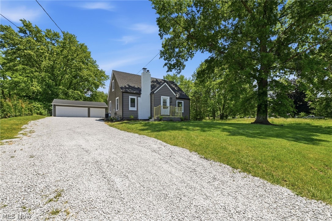 Welcome home to 951 Bey Rd in Springfield Twp! Don't miss this rare opportunity to own a completely renovated 3 bed, 2 FULL bath home w/a 3-car garage, dual laundry hookups & nearly 2 acres of land. This home has had a complete transformation down to the studs. Every detail has been thoughtfully renovated & professionally curated. The open concept floor plan features luxury vinyl flooring, fresh paint, recessed lighting & stylish modern fixtures throughout. The living room showcases a striking black-paneled electric fireplace & flows seamlessly into the dining area. The kitchen boasts bright white cabinetry, glossy subway tile backsplash &  stainless steel appliances that stay. The 1st floor also offers a bedroom & a bath w/beautifully tiled shower, sliding glass doors, coordinating tile flooring & a new vanity. Upstairs you'll find 2 bedrooms separated by a 2nd full bath & a convenient washer/dryer hookup. The waterproofed finished basement has new luxury vinyl flooring & a 2nd laundry hookup—ideal for a recreation room, home office, gym or entertaining area. Outside, enjoy the large 3-car garage w/new doors & openers, a new patio overlooking the expansive backyard & a storage shed. A row of newly planted Green Giant arborvitae trees has been added along the property line & will mature into an impressive natural privacy screen, reaching heights of 40-60 ft. New siding on the garage & new gutters further enhance the property's appeal. Major updates include new roof on the house & garage, windows, plumbing, drywall, insulation, furnace, A/C, hot water tank, doors & hardware, water filtration system, submersible well pump, pressure tank & updated electrical. Conveniently located just minutes from Springfield Lake Park, shopping & entertainment, this property offers the perfect blend of modern updates, privacy & space **For buyers seeking a truly turnkey experience, furnishings, decor & other contents of the home may be negotiated separately w/an accepted offer**