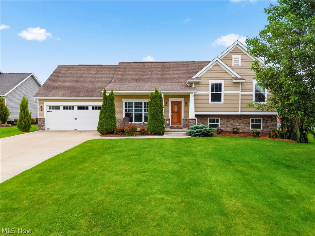 Beautiful street appeal welcomes you to 5858 Birmingham Road in Canterbury Creek, Plain Township. Built in 2017, this newer home offers an attractive stone-and-vinyl exterior, modern comfort, and a desirable neighborhood setting. Features include a two-car heated garage complete with electric, water, and drain—ideal for added convenience or additional workspace. The second floor features three bedrooms, including the owner’s suite with a private full bath, along with an additional full bath shared by bedrooms two and three. The lower level offers a generous family room with an electric fireplace adjacent to a versatile bonus room which can be used as a workout room, etc., providing additional living and entertaining space.Step outside to the private backyard with a beautiful wood-covered patio featuring electric in the ceiling for a TV, lighting, or additional amenities—perfect for relaxing or entertaining. Numerous upgrades throughout the home include a whole-house Generac generator, heated garage, tankless water heater, new carpet, and more. The lovely, well-maintained landscaping further enhances the outdoor setting and overall curb appeal. A truly warm and comfortable home offering inviting living space throughout.