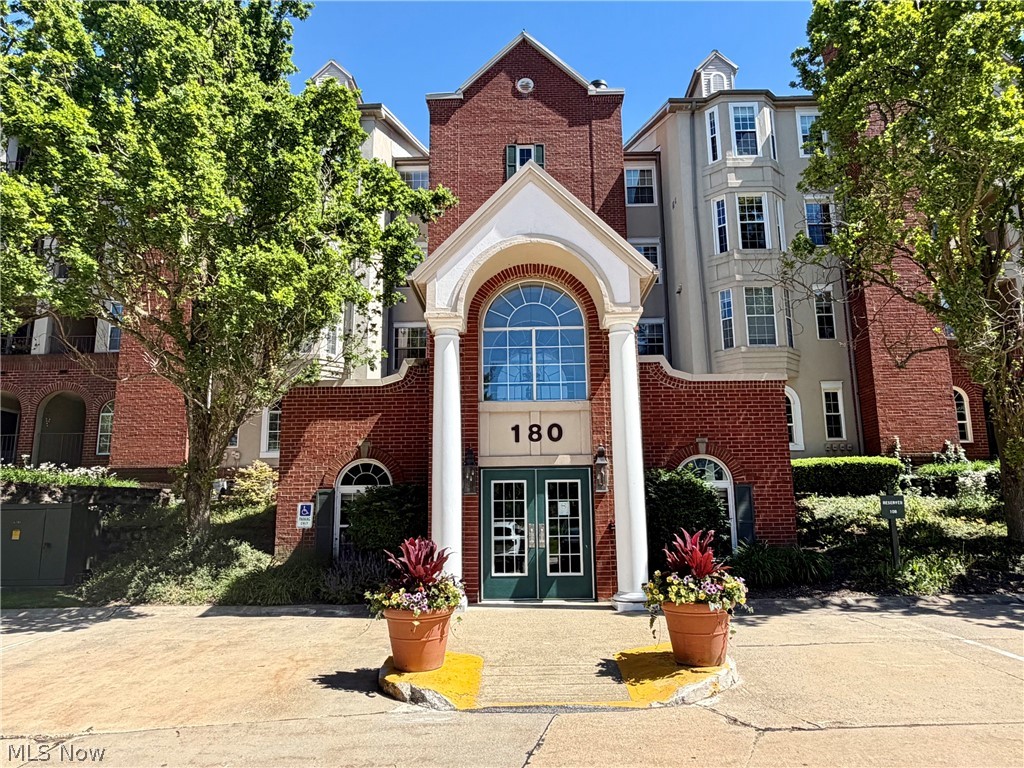 Welcome to this Desirable 1st floor Condo in Woodhawk Community! Easy low-maintenance living in this updated end unit with generous living space, 2 Bedrooms, 2 Full Baths, tasteful neutral decor with updated lighting fixtures & newer LVT plank flooring throughout. Ceramic tile foyer open to both Dining Room & Living Room with electric fireplace. Galley Kitchen with granite counters, all newer appliances and breakfast area with access to private covered balcony. Owners Suite includes walk-in closet & modern custom sliding door to private bath with custom walk-in shower remodeled in 2025. 2nd Bedroom & 2nd updated full bath. In-suite laundry. Heated parking garage with assigned parking space, 2 storage lockers included & additional outdoor parking available. Enjoy the fitness center off the main lobby and all community amenities including 2 swimming pools, tennis courts & clubhouse. 24-hr gated security. Great location....close to shopping, restaurants, Cleveland Clinic Hillcrest Hospital, easy freeway access and just minutes to Legacy Village, Beachwood Mall, Pinecrest & more! 1-yr home warranty. Mayfield Schools.