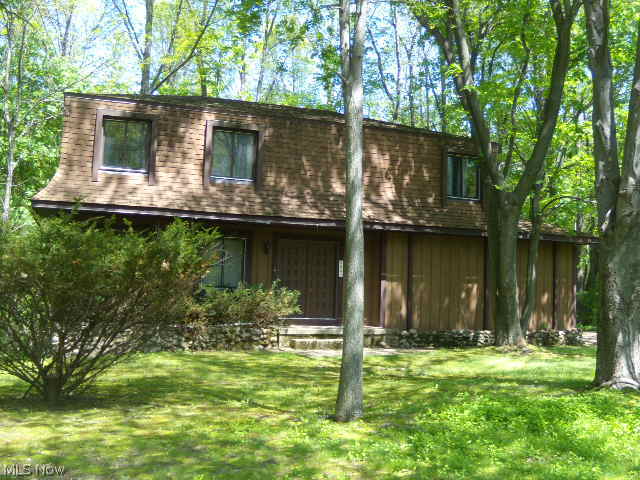 Desirable location! This 2 story, 4 bedroom  2 full and 2 half bath home in Sherman Wood estates is located on a wooded lot which offers an abundance of privacy. The formal dinning room and fire placed family room have sliders that open up to the private wooded back yard. The master bedroom offers it's own full bath and walk in closet.The lower level walk-out has a half bath and workshop area. There is a newer boiler system for zoned heating. Air conditioning  units located in home do not work.Home is being sold AS IS! Seller will not do any repairs. or buyer assistance. Cash or conventional financing only.
