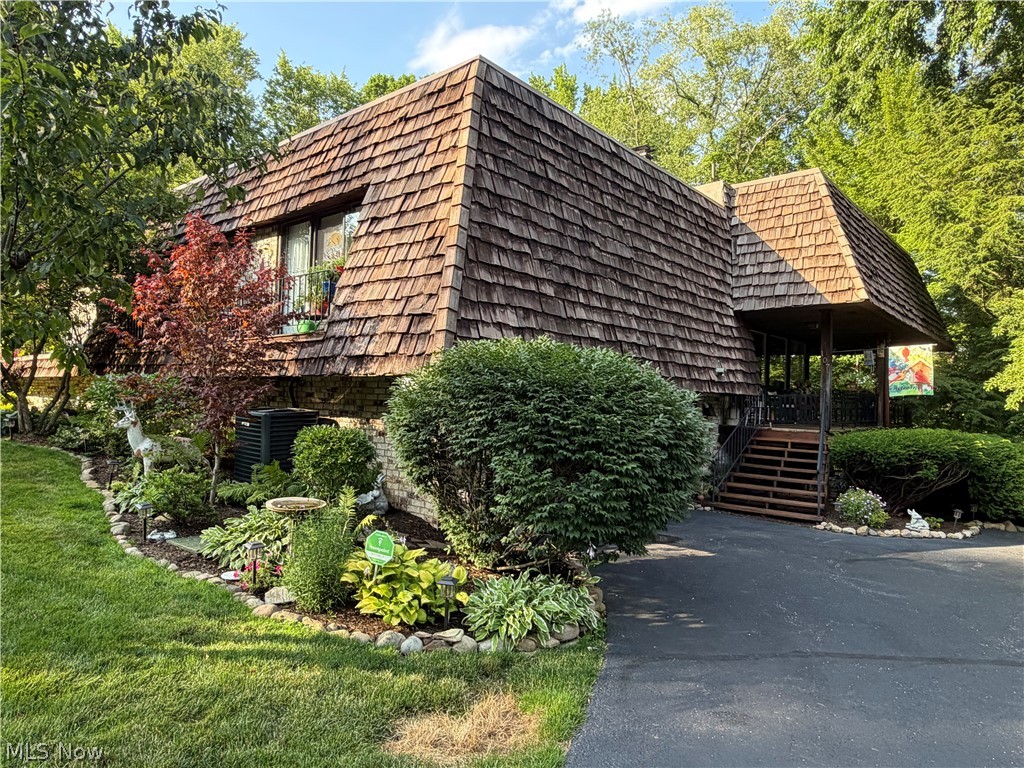 Amazing updated/remodeled 3-level condo-Walk up to the main level to the most spectacular view. With this
open concept floor plan you can stand in the Eat-in Kitchen & Great Rm. and 
look out over the covered wrap around deck into the woods where the deer &
other wild life come around looking for treats. The Great Rm has high ceilings,
full walls of windows, a cozy fireplace for those cold winter nights & bamboo
flooring. The newly remodeled Kitchen is a must-see, featuring new cupboards,
granite counter tops, farmer sink, wine fridge, breakfast bar, lightening & bamboo
flooring with plenty of room for a big table & hutch. On the upper level, you will
enjoy the convenience of having a full laundry room (newly painted & new tile floor
put down) a sink & lots of storage,  plus a full bathroom, newly painted. The spacious Master Suite with a full ensuite, tons of storage, closets, 2 sliding glass doors, overlooking the front deck.
Newer paint and carpet. Check out the lower level: A full bathroom is perfect right
beside a huge rec room overlooking the woods. Could be used for a third bedroom 
or in a home office too. Lots of possibilities.  The lower level does have a beautiful bedroom (newer paint & carpet) a spacious closet with sliding glass doors overlooking
 the amazing backyard patio, partially covered. Check out the Koi pond (fish do not stay). So peaceful back there, you will
 never want to leave or invite your friends for a little party. A great place to hang out. 
 Also, you will find an attached 2-car garage that has been newly painted with a new
garage floor installed.  Off of the garage in the back is a workshop and/or extra storage.
Enjoy resort-style amenities including, tennis & pickleball courts, a private lake with a dock. You can fish on this lake or take out your paddle boats, kayaks, or canoes. There is a party center there that you can rent out for all your special occasions.
 Hurry & make this your home today!