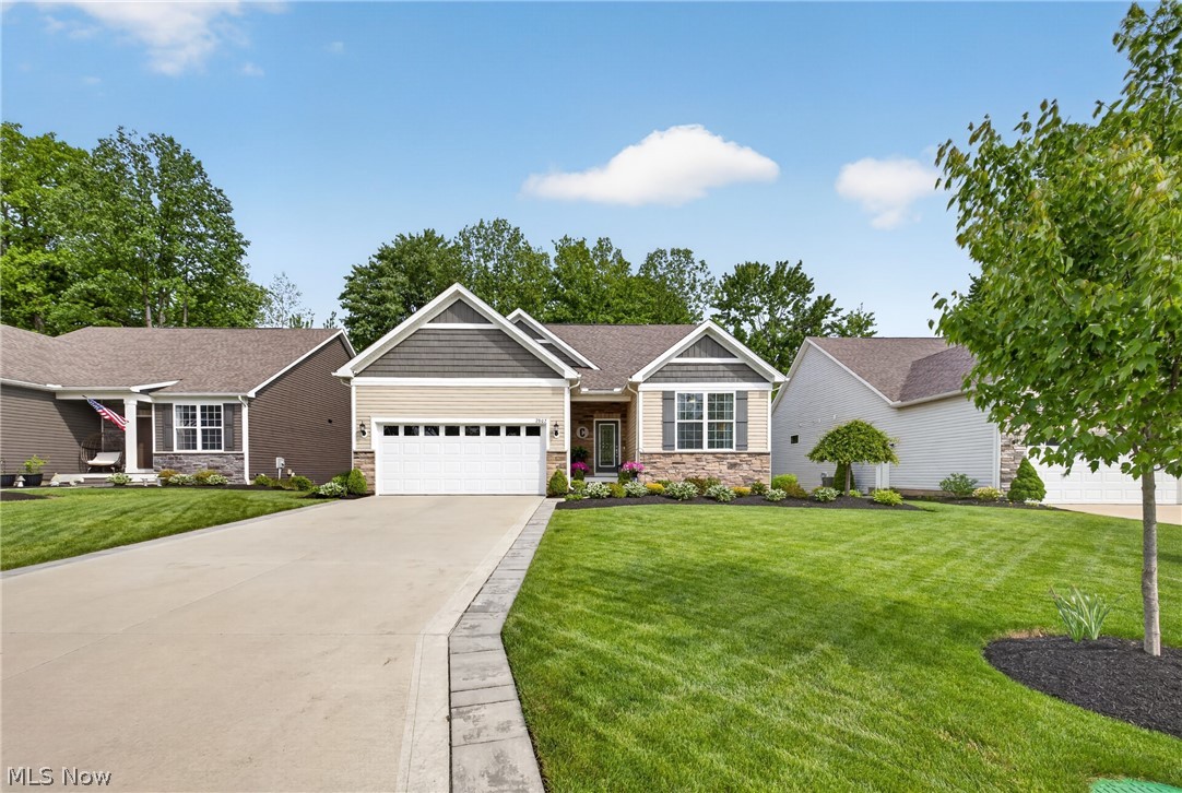 Welcome to upscale, low-maintenance living in the highly sought-after Quail Hollow community! This beautiful ranch-style home, featuring the perfect blend of comfort, elegance, and lifestyle living. Nestled on a gorgeous wooded homesite with golf course views and the 13th hole of Weiskopf beyond the trees, the setting is both peaceful and picturesque. Designed with downsizers in mind, this thoughtfully crafted home features 2 bedrooms, a cozy den, and an open-concept layout ideal for everyday living and entertaining. The stunning kitchen showcases a large center island with seating, stainless steel appliances. The kitchen flows seamlessly into the great room, highlighted by a warm fireplace and upgraded flooring throughout. The spacious Owner’s Suite offers serene views and a luxurious bath. An oversized 2-car garage has a heater 2022 and provides extra storage, while the full basement includes 10-foot ceilings, daylight windows, and a bath rough in. All mechanics 2021, stainelss steel appliances stay 2021, Roof, 2021, Windows 2021. Additonal updates: Insulated Garage door 2025. garage insulation 2022. glass panel front door 2023, compsite deck 2022. Generac Generator operates appliances, furance, hot water heater and master bedroom and bath. There is a front and back yard irigation system. Residents enjoy access to the exceptional amenities of Quail Hollow Country Club, including fine dining with indoor and outdoor seating, fitness classes, an Olympic-sized pool, two championship golf courses, and year-round social events.