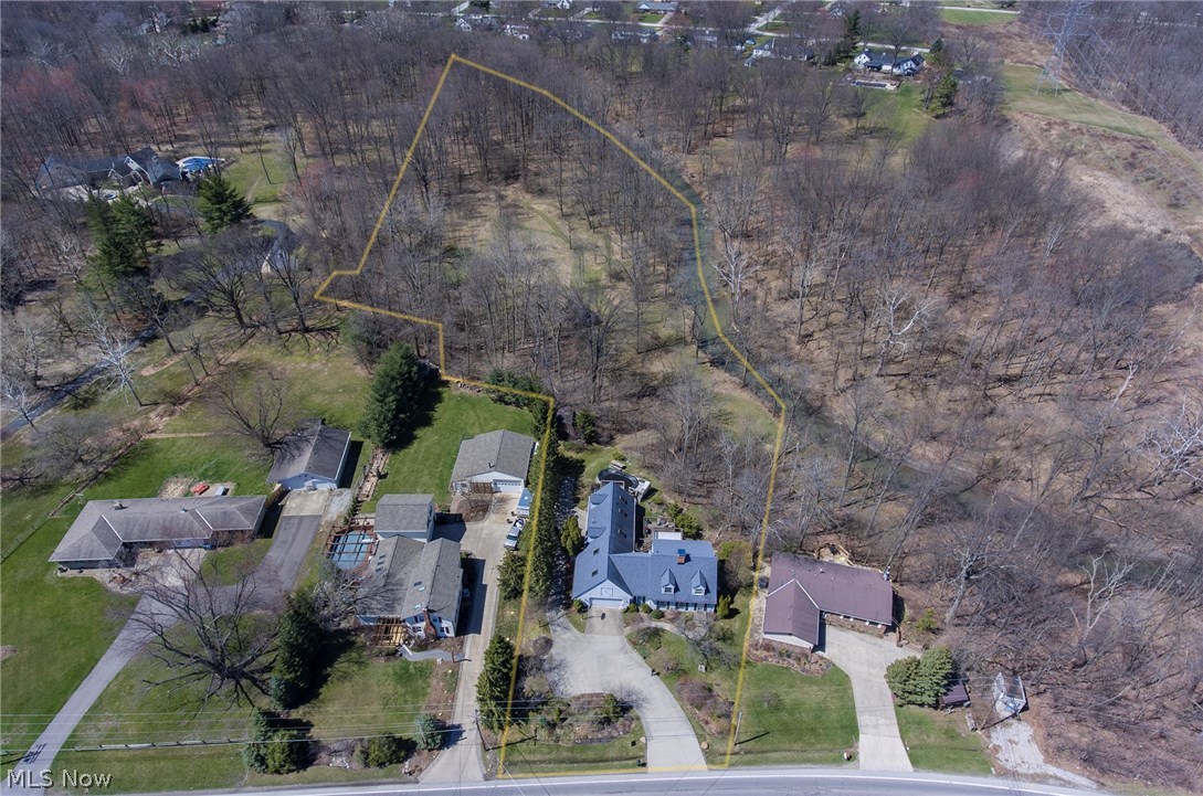 Amazing home! Scenic, 4.8 acres bordering over 735 feet of Beaver Creek. Park-like setting. Incredible views. Luxurious 4774sqft finished. Two in-law suites with separate entrances.  Impeccable quality throughout. 5 bedrooms and 4 full baths. Solid oak wood doors. Beautiful oak kitchen with beveled wood edge counter tops and center island breakfast bar. Gorgeous 17x16 Great room with beautiful hardwood floors, full out bay window, and Vermont Casting woodburning stove. Living room has 2 story ceiling, balcony to second floor, and new carpet. Multi-level decks off the back of the home. 14x13 balcony off master bedroom. French doors on master bedroom and remodeled master bath with luxury vinyl floor and tile shower. Large deck off 14x13 sunroom with new windows '05, and porcelain floor. 22x13 office off the garage. 1048 sqft Finished, walk-out basement with in-law suite and patio. Two heated garages for 4 cars. 3422sqft, 3 car wide driveway with turnaround in '02. Luxury, 880sqft apartment addition, with 12x8 deck and 2 car garage '99. New roof in '07 with 50yr shingles. 2 Rheem gas furnaces. 2 Arco Air conditioning units, '16 and '03. Nice 25x24 horse barn, 2 stables, pasture and woods along the creek below. Central vacuum system. Professionally landscaped, 8-station sprinkler system, and 10 landscaped garden areas. Newer, 24x12 above ground pool. Home Warranty included. Approved horse property in Amherst city and Amherst schools. Possible rental with Air BNB if desired.