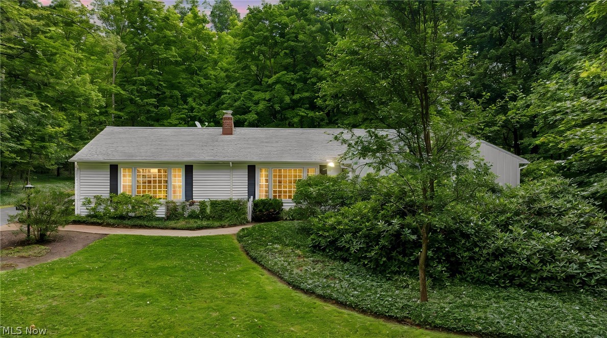 Welcome to this one-owner ranch home in Chardon’s desirable Bass Lake area, set on 2.21 private, wooded acres across two parceled lots. Designed for convenient first-floor living, the home offers 3 bedrooms, 2.5 baths, and comfortable spaces for everyday living and entertaining. This ranch style home has so much to offer including a very spacious great room with gas fireplace, Cypress paneling and built-in cabinetry, hardwood floors throughout, an updated kitchen with plenty of storage and a peninsula with bar seating. All appliances are included. Enjoy morning coffee or summer evenings in the lovely sunroom or out on the private deck. Convenient main floor laundry, attached 2 car garage, full basement and a whole house generator for piece of mind. This home has been owned and well cared for by the same family since it was built in 1961. Located just minutes from Chardon Square, restaurants, stores, shops, parks and 6 miles from UH Geauga Medical Center. Water potability and septic both passed inspection just prior to listing (see supplements). Don't miss out on this wonderful opportunity to make this home yours!