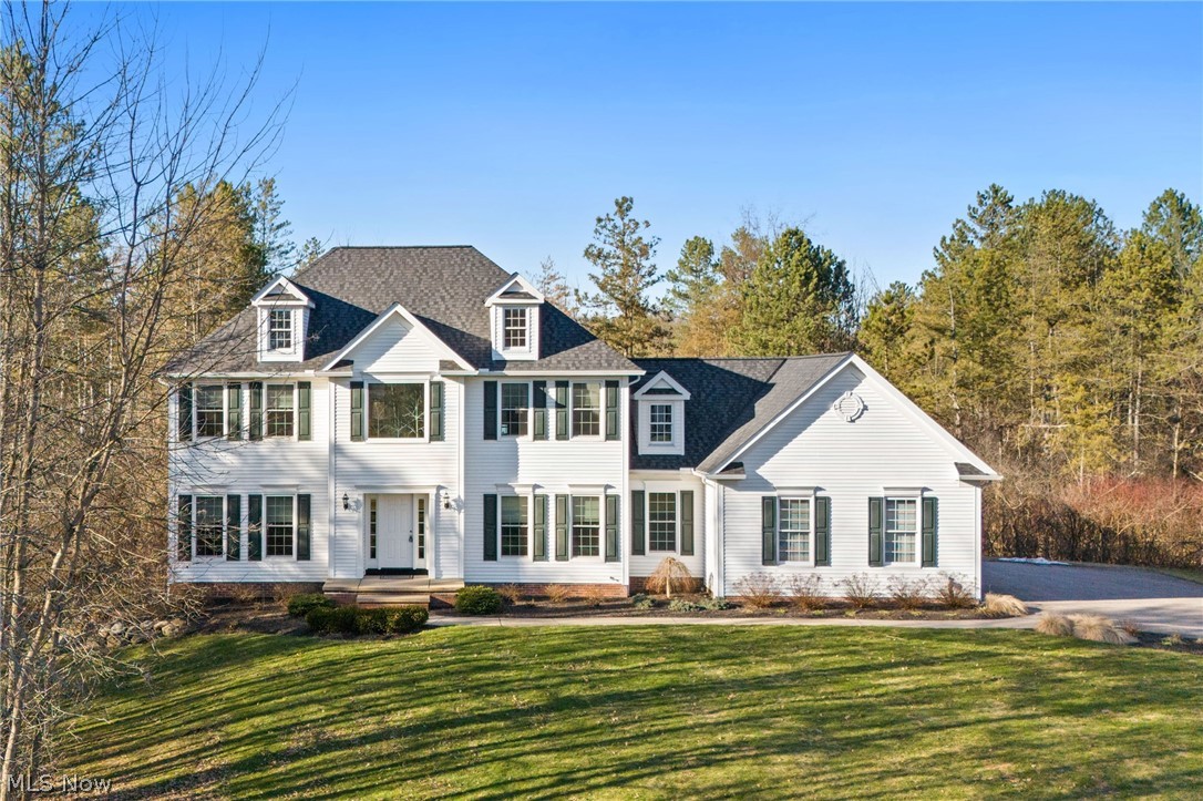 Immaculate Colonial set on 2.5+Private Wooded Acres in Munson Twp! This beautifully updated and spacious home boasts over 3800 finished sqft of living space with 4 Bedrooms, 2 Full Baths, 2 Half Baths, freshly painted interior and desirable floor plan. 2-Story Foyer entrance welcomes you to both Dining Room & 1st floor Home Office. Bright and light Family Room with gas fireplace and open to the recently updated Kitchen with new custom cabinetry, granite counters with breakfast bar, fixtures, recessed lighting, appliances & vaulted Dining area with access to deck. Vaulted Master Bedroom Suite with walk-in closet & Glamour Bath with his & hers vanities, jetted tub & separate shower. 3 additional Bedrooms with full bath to share complete the second floor. 1st floor Laundry Room and half bath. Full finished lower level includes Rec/Media/Play Room with half bath, walk-up access to garage or walk-out to patio & fenced-in area for pets or play area for kids. New Roof installed 2024. Pella windows installed 2022. Enjoy entertaining this summer on the expansive composite deck overlooking deep backyard. Situated in quiet community....this home is surrounded by mature trees with beautifully landscaped yard and manicured beds full of lush plantings. Paved drive, 3+car attached garage. Ideal home for the growing family....Must see to appreciate all this home has to offer inside & out! Close to Geauga Parks, NDCL, Alpine Valley, YMCA, UH Geauga Hospital and just minutes to Chardon Square!
