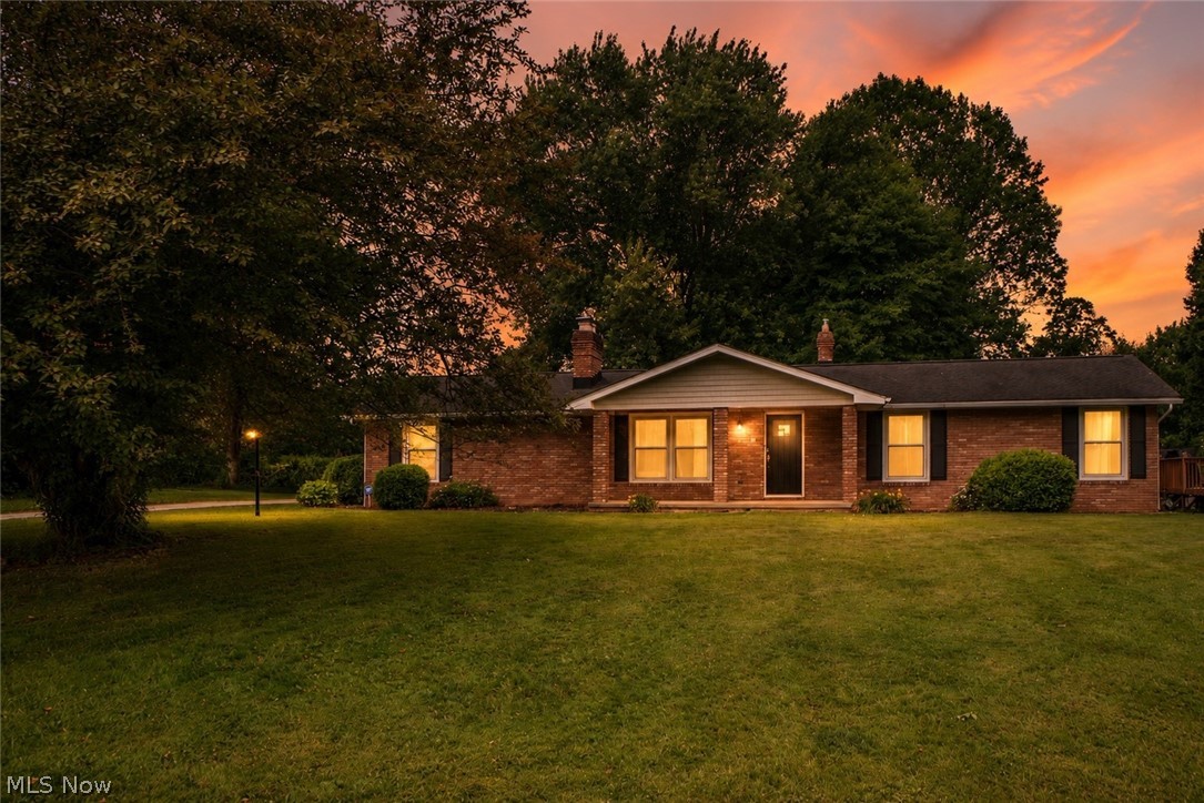 This charming brick ranch in Hannshire Estates offers comfortable one-floor living in a quiet, convenient Canal Fulton neighborhood. A covered front porch welcomes you into the spacious living room, where newer flooring and a floor-to-ceiling stone wood-burning fireplace create a warm and inviting first impression. The updated eat-in kitchen features cherry soft-close cabinetry, stainless steel appliances, a coffee bar, ceramic tile flooring, and sliding doors that open to the backyard. Down the hall, you’ll find three bedrooms, including a primary suite with its own full bath, plus an additional full bathroom. The finished lower level adds even more living space with a large recreation room, second wood-burning fireplace, laundry/utility area, and plenty of room to gather, relax, or entertain. Outside, enjoy over half an acre with a detached deck, storage shed, and playground that conveys. Additional highlights include an attached 2-car garage, newer flooring and paint throughout, and updated electrical in 2016. Close to restaurants, shopping, and everyday conveniences!