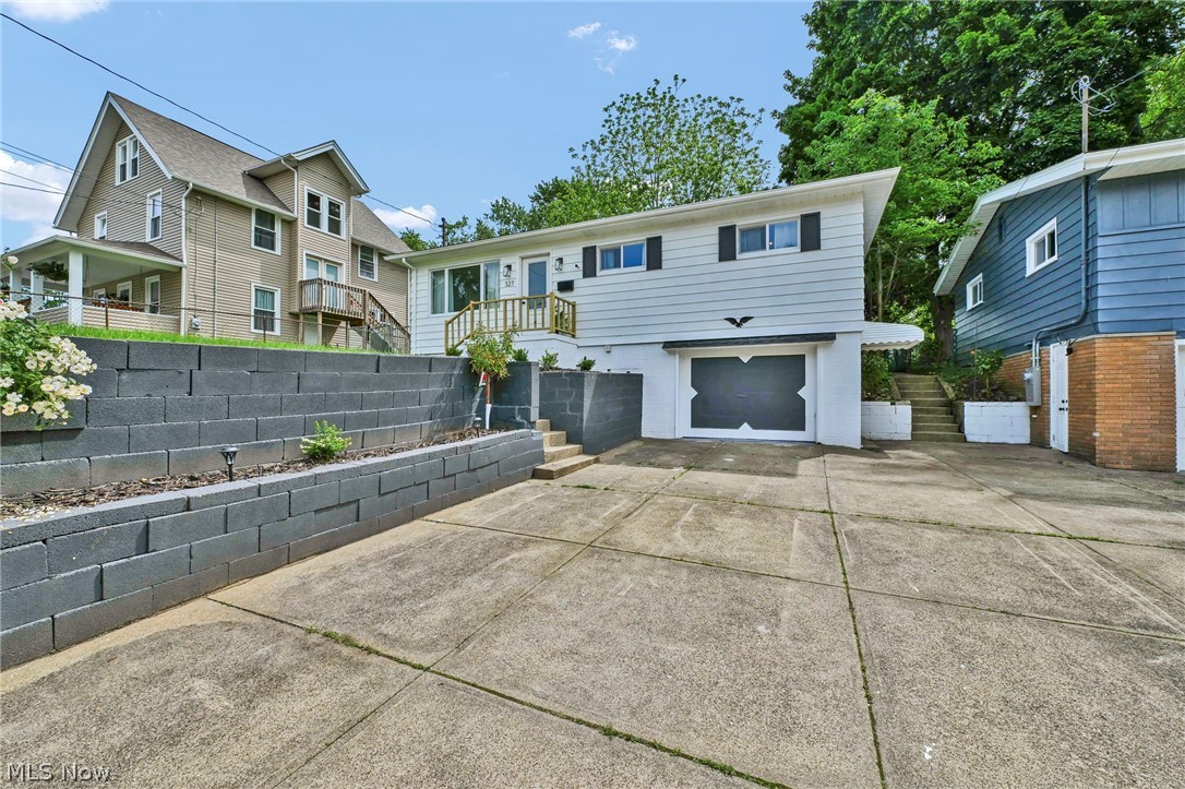 Welcome home to 327 Horton Ave in Ellet! This beautifully updated 3 bedroom, 2 FULL bath elevated ranch is much larger than it appears. The sun-filled living room features a large picture window that floods the space with natural light, creating an inviting atmosphere. The heart of the home is the stunning bright & airy eat-in kitchen that boasts white cabinetry, sleek stainless steel appliances that stay with the home, a vented range hood & a modern backsplash. Large windows overlook one of the home's standout features—the spectacular 3-seasons room that feels like an extension of the living space. Surrounded by windows on every side, it's the perfect spot to relax, host guests, or simply take in views of the massive fenced backyard. The main level offers 3 generously sized bedrooms w/great closet space & an updated full bathroom featuring beautiful tile work, recessed lighting & stylish finishes. The spacious finished lower level adds even more room to spread out. Complete with a cozy electric fireplace, built-in bench seating, a 2nd FULL bathroom & access to the deep one-car garage, this versatile space is perfect for a family room, recreation area or home office. The updates continue throughout the home, including new luxury vinyl flooring, contemporary light fixtures, fresh interior & exterior paint & new interior/exterior doors. This home also comes w/major updates for your peace of mind, including brand-new roof, windows, furnace, central A/C, plumbing & electrical panel. There's absolutely nothing to do except unpack & enjoy. *Bonus: All furniture included with an accepted offer at full asking price* Schedule a tour today!