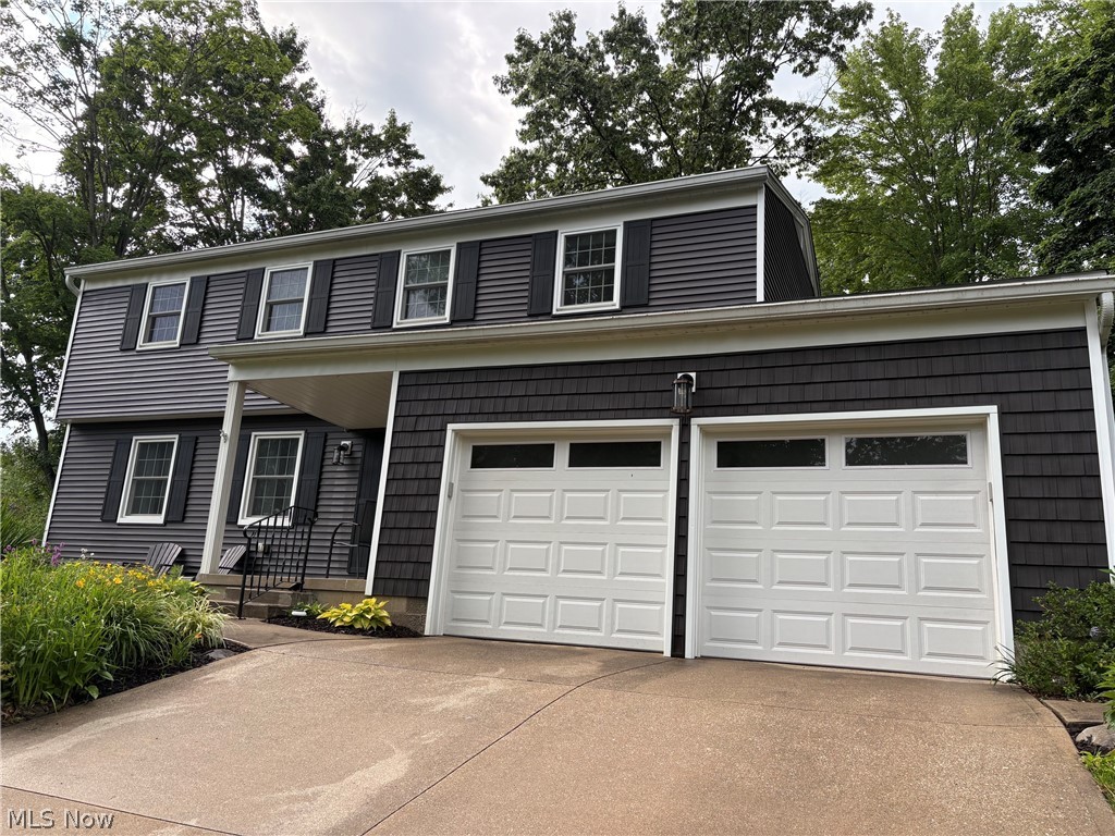 Visit this wonderful colonial in Copley-Fairlawn School District just seconds from Herberich Elementary. It features 2,500 finished square feet and an open 49 x 16 area in the basement that has been freshly painted and can be used for many purposes. The home is situated on a quiet street on a third of an acre, featuring beautiful landscaping and a large wooded backyard with complete privacy fencing. The home features a front porch and front yard and back yard patios with ample space for entertaining and play areas. Most of the home boasts hardwood floors and the rooms are large with many large windows and open spaces. The main floor provides an open and inviting Living Room and Family Room with a beautiful whitewashed fireplace and a slider to the back patio. The Kitchen provides a Breakfast Nook open to Family Room and the Kitchen area that is open to the Dining Room. The main floor also includes a half bath and access to the two car garage. The second floor offers an oversized owner's suite with a large walk in closet and an ensuite bath featuring a new shower door and plenty of room for getting ready in the morning. The other three bedrooms share the updated hall bathroom and feature nicely sized closets and windows. The basement includes a Recreation Room and the huge open area that the entire family can use. Updates include a 2019 stained floor, new tile and vanity in the hall bathroom, removed walls for an open floor plan on the main floor, 2020 all new siding on the home and a new roof, 2021 Patio and Retaining Wall in backyard, 2023 front yard patio, and a 2025 new Hot Water Tank and new backyard Shed. Make new memories in this ready to move in home. This home offers incredible space in a prime location.