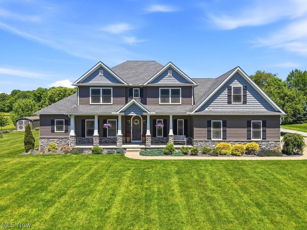 Welcome to this exceptional custom built home nestled on 4 acres in desirable Lake Township but still in North Canton School District. Offering over 5,000 square feet of finished living space, this property combines luxury, functionality, and plenty of room to grow!
The thoughtfully designed floor plan features 5 bedrooms, 3 full baths, and 2 half baths, including a spacious first floor owner's suite. A private first floor office provides the perfect work from home space and could easily serve as a 6th bedroom if desired.
At the heart of the home is a stunning kitchen featuring handcrafted Amish built custom cabinetry, granite countertops, large island with prep sink, and pantry all flowing seamlessly into the open living space with gorgeous 2 story great room and open loft area on the second floor. Upstairs you will find 4 bedrooms. 2 of them sharing a Jack and Jill bathroom and another full bath. The upstairs vanities have built in step stools for the little ones! The attention to details in this home are remarkable! The owners even converted a storage closet into a craft area for the kids. The large bedroom over the garage also has walk in attic storage for convenience. All the bedrooms have walk in closets except that one. The finished lower level features a theatre room,  plenty of open space for recreation, a work out area, and a bonus office tucked back in the corner. Outside, you'll enjoy the peaceful country setting with open acreage, garden area, playhouse, and storage shed. The impressive 30' x 46' outbuilding provides endless possibilities for hobbyists, storage, equipment, or workshop space. An outdoor kitchen complete with built-in grill and refrigerator creates the perfect setting for summer gatherings and outdoor entertaining. Whole house generator for added convenience. This truly one of a kind property offers the privacy of country living with convenient access to North Canton amenities, schools, shopping, and dining! All without paying city tax!