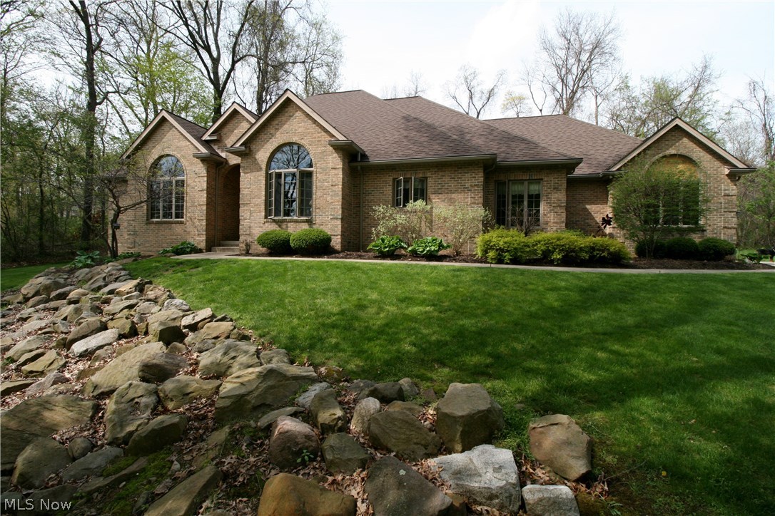 Must see! This one of kind all brick ranch sits 300+ feet off the road on a 5 acre wooded lot, creating a private and relaxing feel. A paved drive takes you up to the 3 car garage. Step inside and see the beautiful oak cabinets, floors, and trim. Off the kitchen is a breakfast nook, and the other side sits beside the faulted-ceiling formal dining room with stunning views out of Anderson windows. The living room boasts 15ft ceilings, has a wood burning fireplace and provides access to your back serene patio. Master suite sits away from the other bedrooms with a large bath, including a whirlpool tub and shower, his and hers sinks with a huge walk in closet. There is even room for an office or 4th bedroom, your choice.  All bedrooms have walk in closets! 13 course basement  ready to be finished with rough in for a full bathroom. High efficiency furnace. Gutter toppers. First floor laundry. This home was built to provide easy and efficient living. Don't let this fantastic home get away.