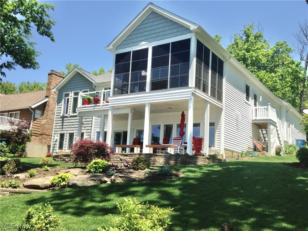 Welcome to paradise on the Portage Lakes! This home built in 2014 features far more than quality construction, it provides a way of living. If you know anything about the Portage Lakes, it’s all about location and views and this home has both. The open great room with high ceilings faces west where you can watch the most spectacular sunsets from the open deck, or the three-season screened sunroom. The master suite faces the lake side and has two walk in closets, a large en-suite bath with jet tub, double vanity and large custom tiled shower. The great room with ambient lighting and gas fireplace is open to the foyer and formal dining area all with vaulted ceilings. The kitchen is nice and bright with white cabinetry, stainless steel appliances, double oven, island with gas cook top and walk-in pantry. The main floor is where you will find the spacious laundry room. The two additional bedrooms have en-suite baths and enjoy full views of the lake with a row of windows in each bedroom. An