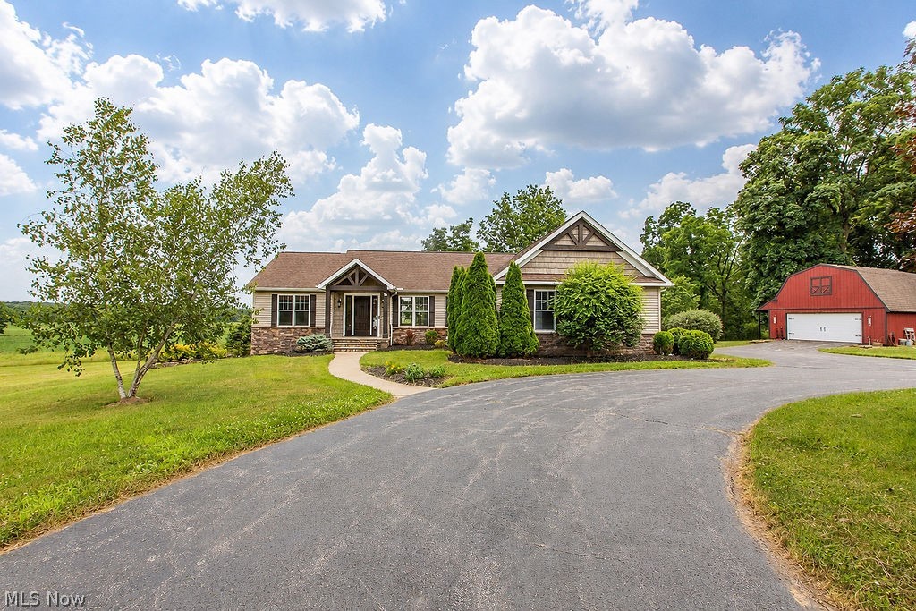 If you are a sunrise lover, you must consider 9503 Mennonite Rd with a total of 2979 sq ft of living space. You’ll feel how special this property is as soon as you make your way down the long tree lined drive way. The 5.6 acre property used to have a farm house believed to be built in 1850. The original owners and their builder carefully chose timeless items from the original home and incorporated them in this home when built in 2009. Original poplar wood floors in the kitchen are under the new LTV flooring, porch wood ceiling, slate, sandstone & beams are a few of the items. The Great room with fireplace is open to the kitchen. Cambria countertops, stone backsplash, Custom made maple cabinets, & newer appliances make cooking a breeze in the fabulous kitchen. The primary suite offers a private bathroom w/ tile shower and has access to a screened porch that overlooks the property with million dollar views. Bedrooms 2 & 3 are expansive and share a full bath. The Laundry Room offers built in storage areas and a window seat. The walk out lower level reveals a living room room w/ stone fireplace, a full bath and bedrooms 4 & 5 w/egress windows. The property offers a spring fed pond, a fire pit area, a chicken coop, a barn with electric, water, loft and so much more. Park your RV in the 5th wheel area with septic hook up, electric, purified water from the house. Quality and beauty is found at every turn in this home. Updates include: New Carpet 2026, Painted 2026, Appliances 2021, HVAC 2021, Pond drudged 2021, Aerator pump 2023. Make this gorgeous home yours today!