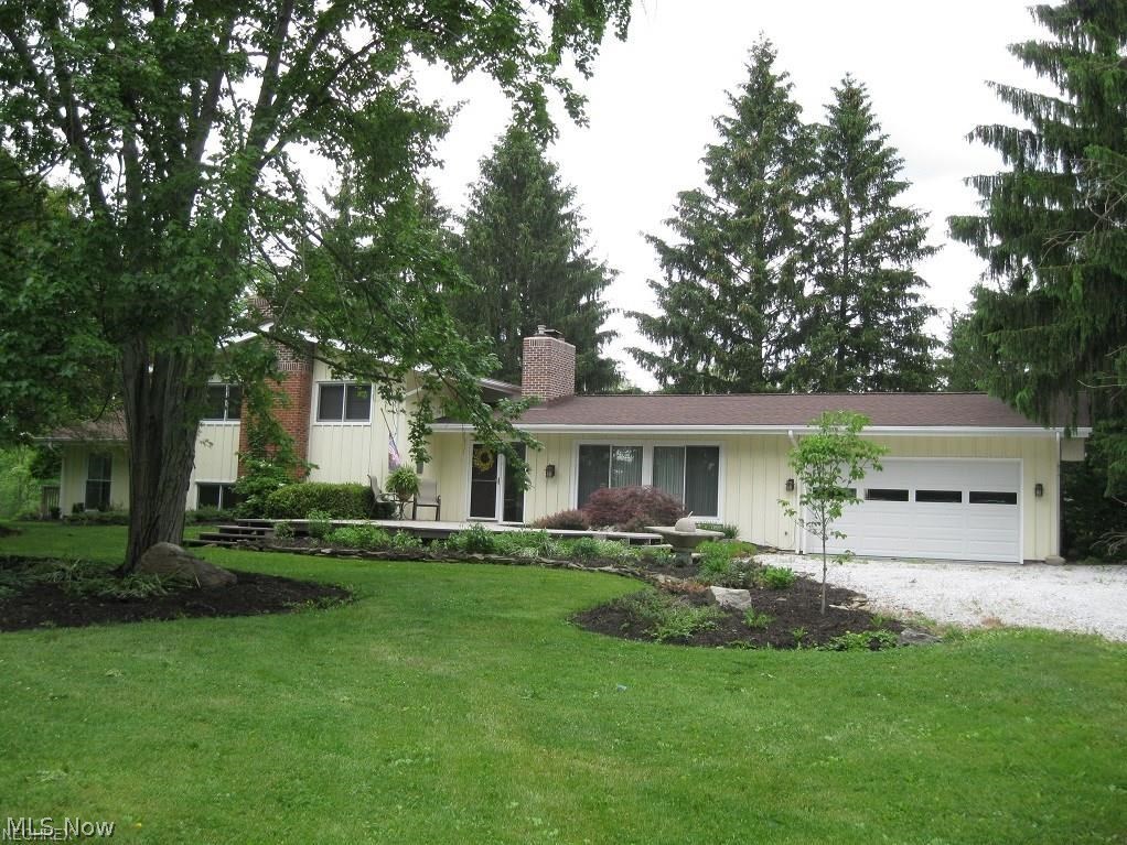 Measure your happiness by the yard! See the forest and the trees! Gardeners and nature buffs will behold a world of wonder on this wonderfully rolling lot. Minutes from downtown Hudson is this tastefully updated and well cared for home, tucked back from the street view on 2.87 acres. Enjoy lovely views of landscaped property via numerous sliding doors and windows. Large living room featuring fireplace and panoramic window. Over size vaulted eat in kitchen, featuring granite counter tops, stainless steel appliances, dbl. oven and much much more. Convenient first floor laundry/mudroom and bath are on this level. Upper level offers three bedrooms and updated full bath. Many possibilities with the oversize bonus room. Great for teenager game room, in home office with separate entrance or many other options. Included is a 775 s.f. heated and cooled outbuilding with plumbing and electricity.  Current owner used as dog boarding and grooming business, equipment available. Possible work shop, h